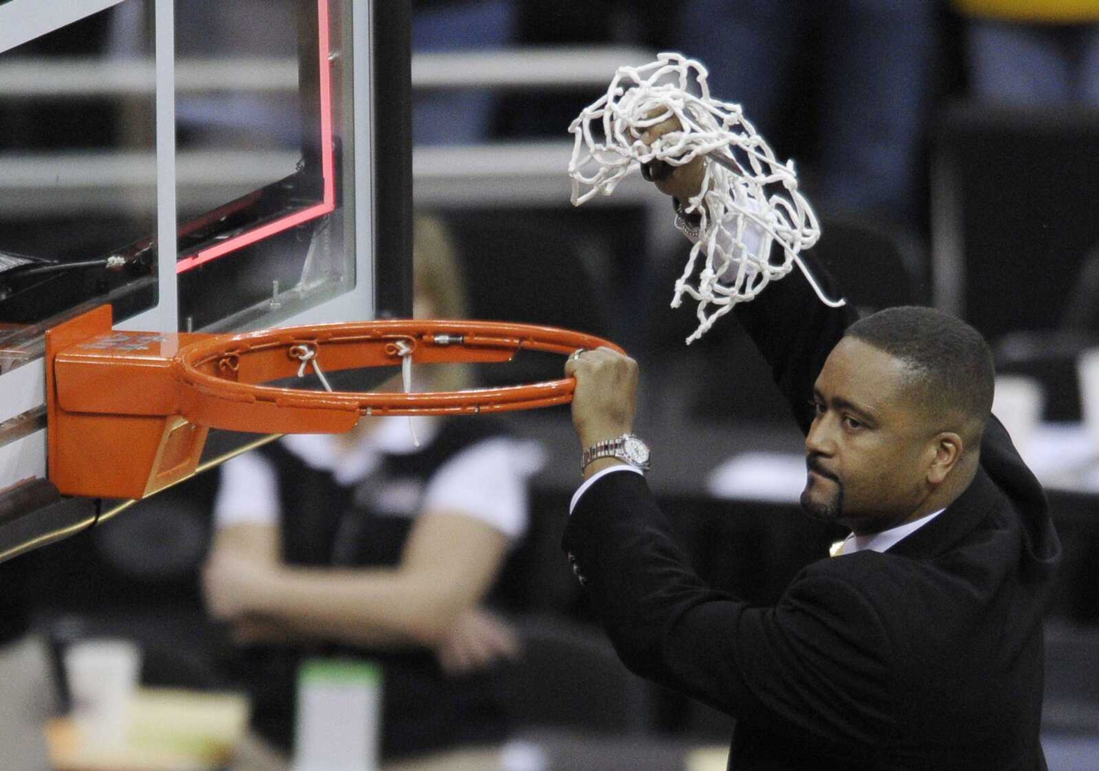 Missouri coach Frank Haith cuts down the net after the Tigers won the Big 12 Conference tournament Saturday in Kansas City, Mo. (REED HOFFMANN ~ Associated Press)