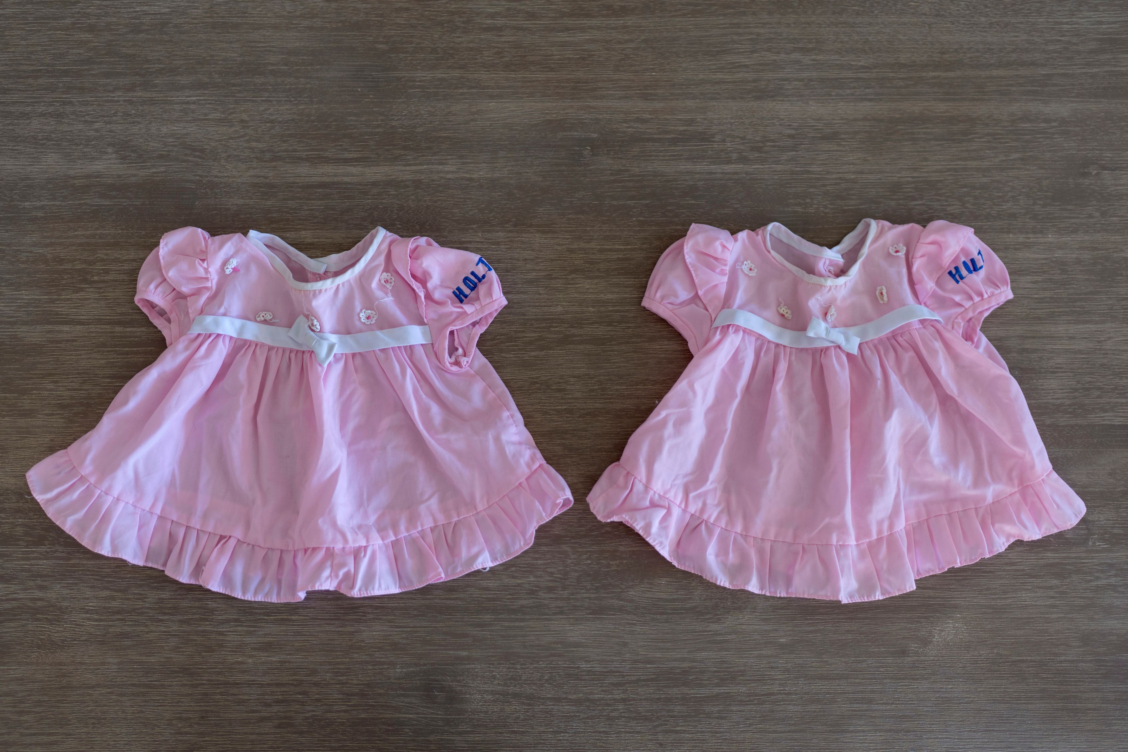 The baby outfits of twin sisters Dee Iraca and Becca Webster, worn on their trip from South Korea when adopted by a family in the United States, are displayed in Iraca's home Saturday, April 6, 2024, in Davidson, N.C. (AP Photo/David Goldman)