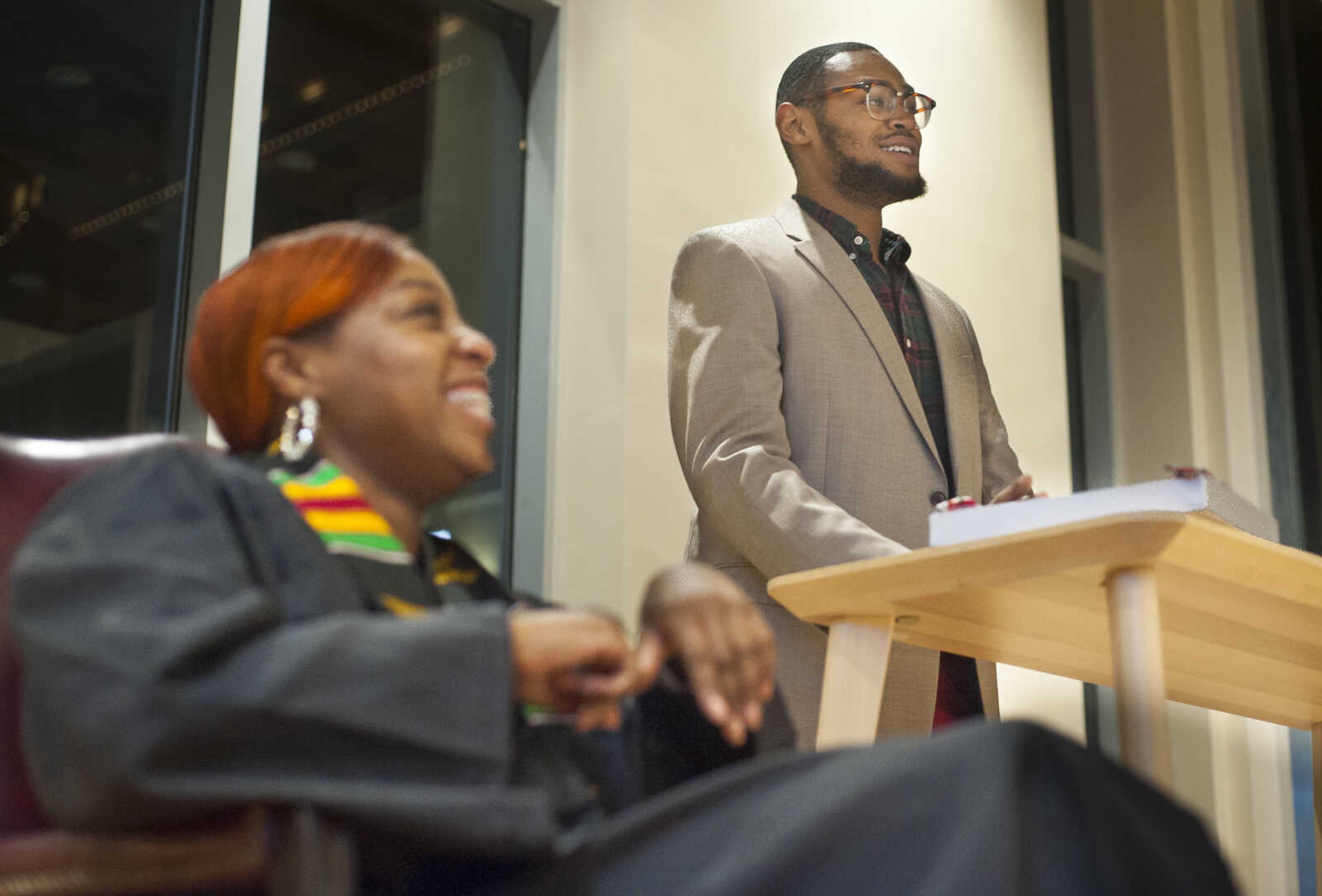 Jasmine Massey laughs as Patrick Buck, president of the National Association of Black Journalists at Southeast Missouri State University, gives the opening remarks at the inaugural "Donning of the Kente" ceremony Monday, Dec. 9, 2019, at Rust Center for Media, which recognized graduating NABJ members.