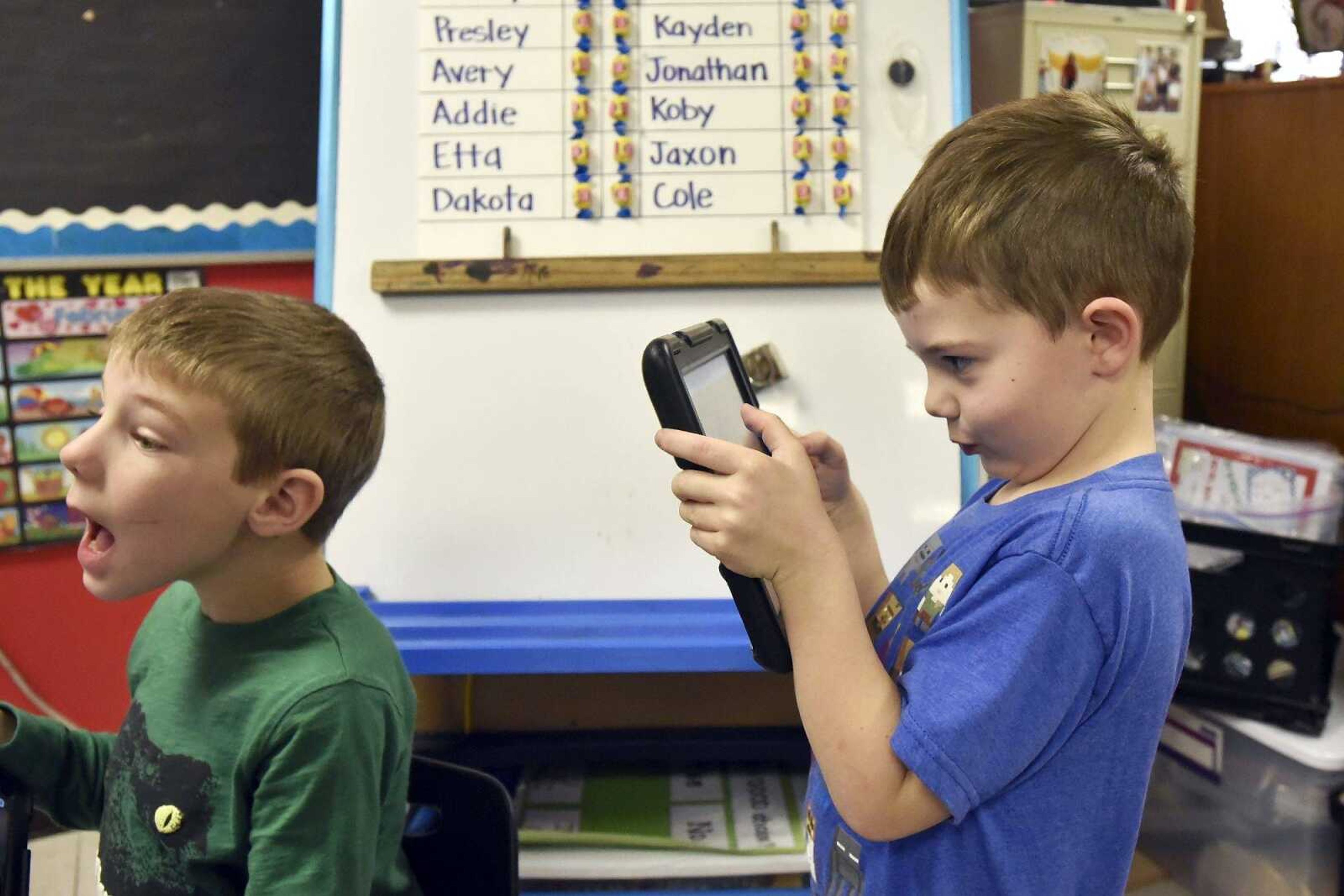 Jonathan Roe, right, sneaks a photo of Kolten Geske using the Seesaw app on his iPad on Friday, Jan. 6, 2016, in Jennie Pehle's kindergarten class at Orchard Drive Elementary in Jackson.