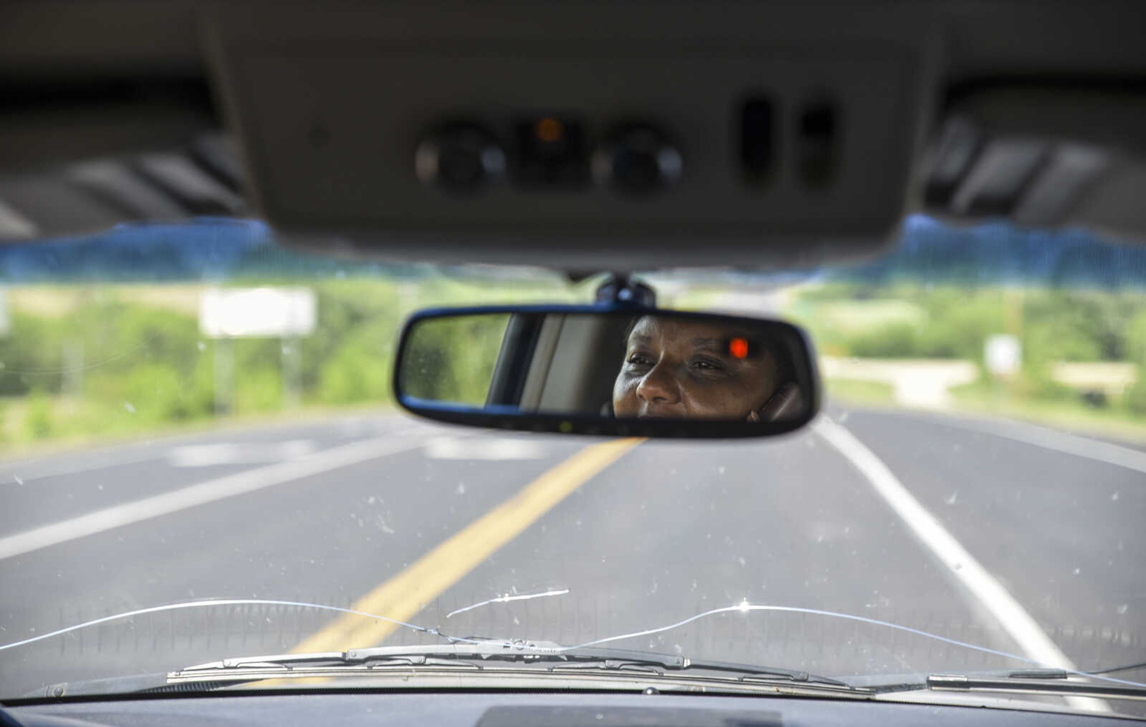 Pat Jackson, David Robinson's wife, is reflected in her rear-view mirror talking to Robinson on the cell phone as she drives to the Jefferson City Correctional Center after receiving news her husband was to be released Monday, May 14, 2018 in Jefferson City.