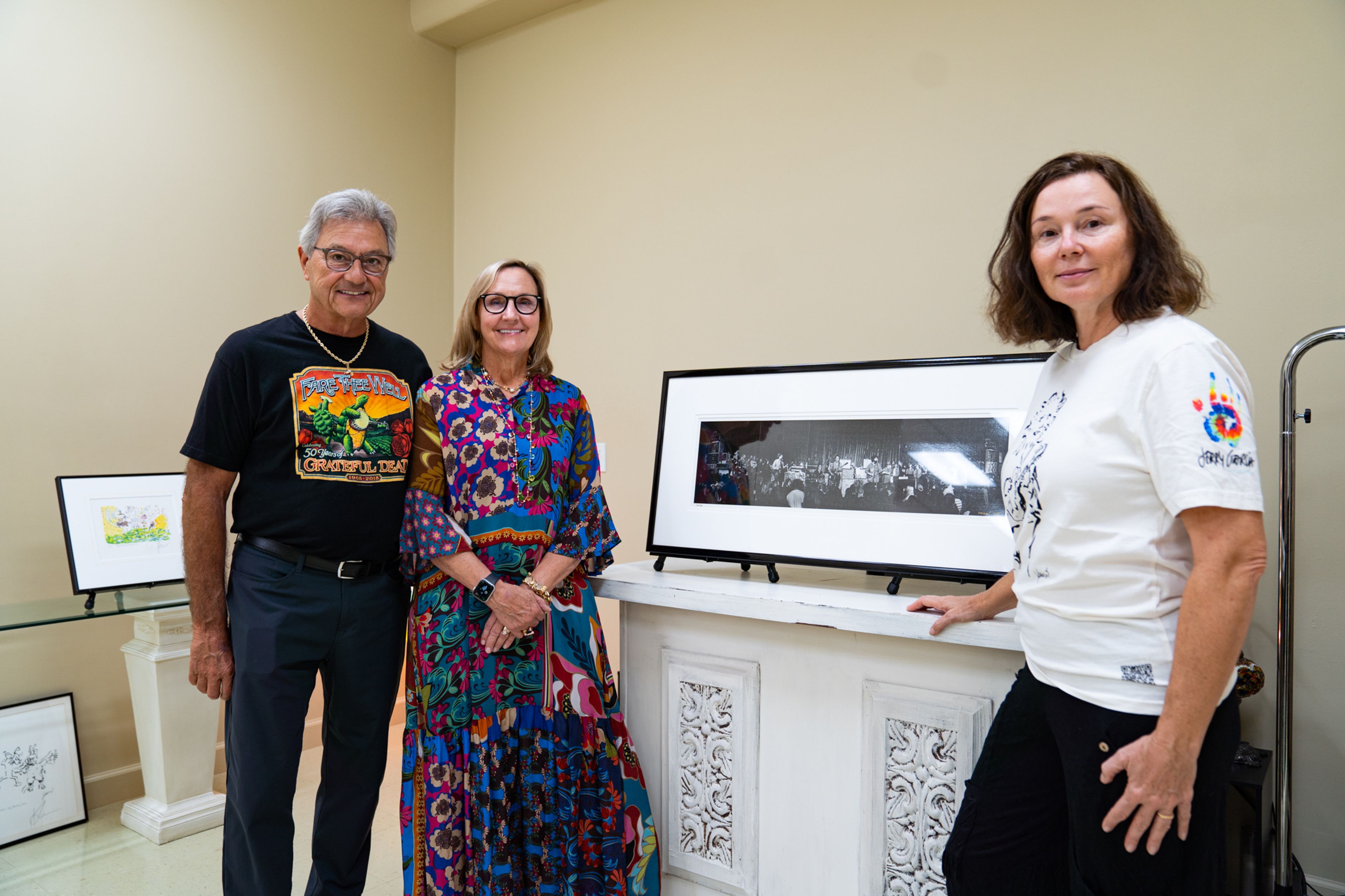 (Left) Keith Holloway, wife Kathy Holloway and owner of Yoga East Healing Arts Studio stand by an art piece in Jerry Garcia Art Exhibit on Friday, Sept. 20 at Yoga East Healing Arts Studio. Holloway showed his collection of Jerry Garcia art to raise funds for the Jack Finney Foundation.