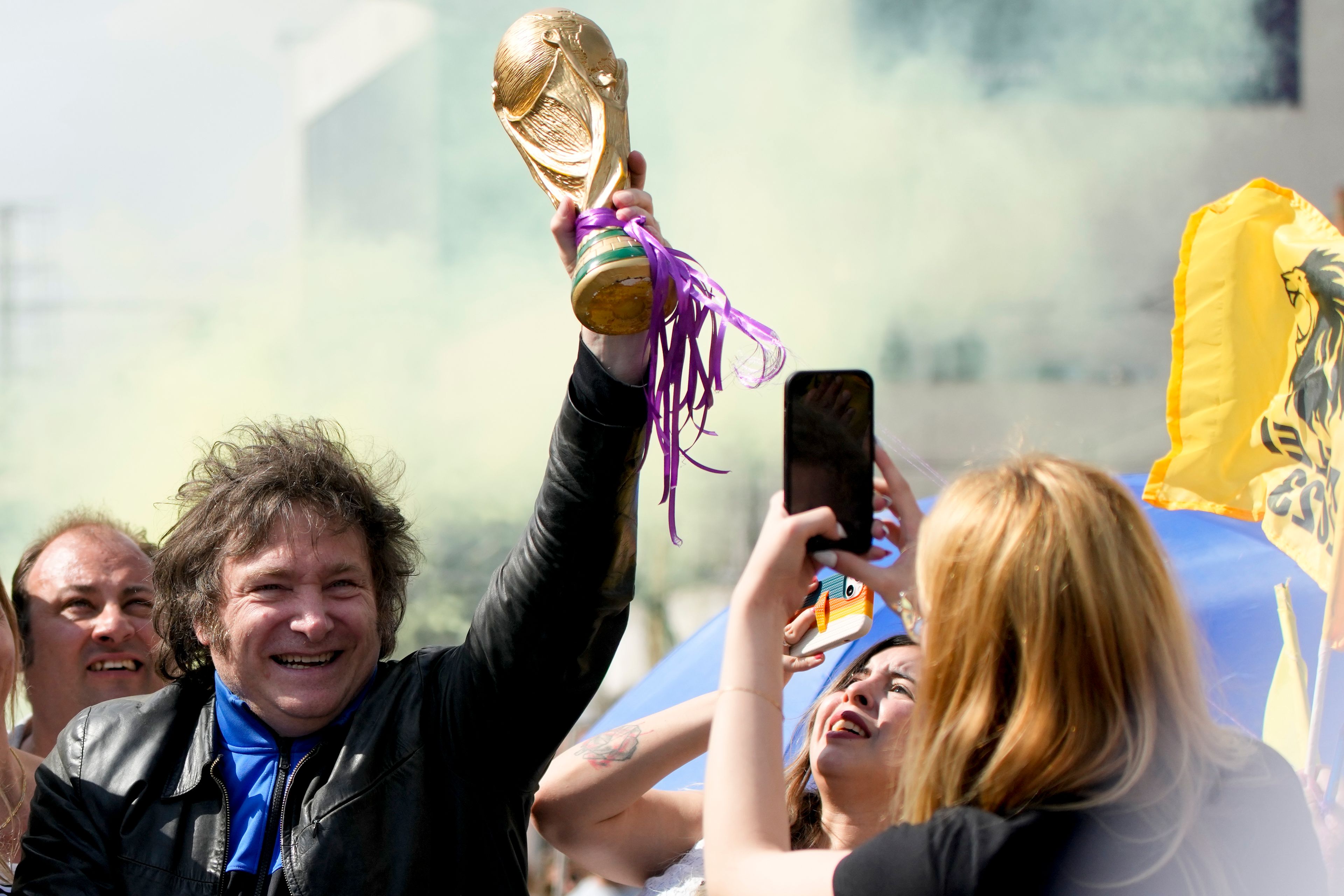 FILE - Presidential hopeful Javier Milei holds up a replica of the World Cup soccer trophy during a campaign rally in Lomas de Zamora, Argentina, Oct. 16, 2023. (AP Photo/Natacha Pisarenko, File)