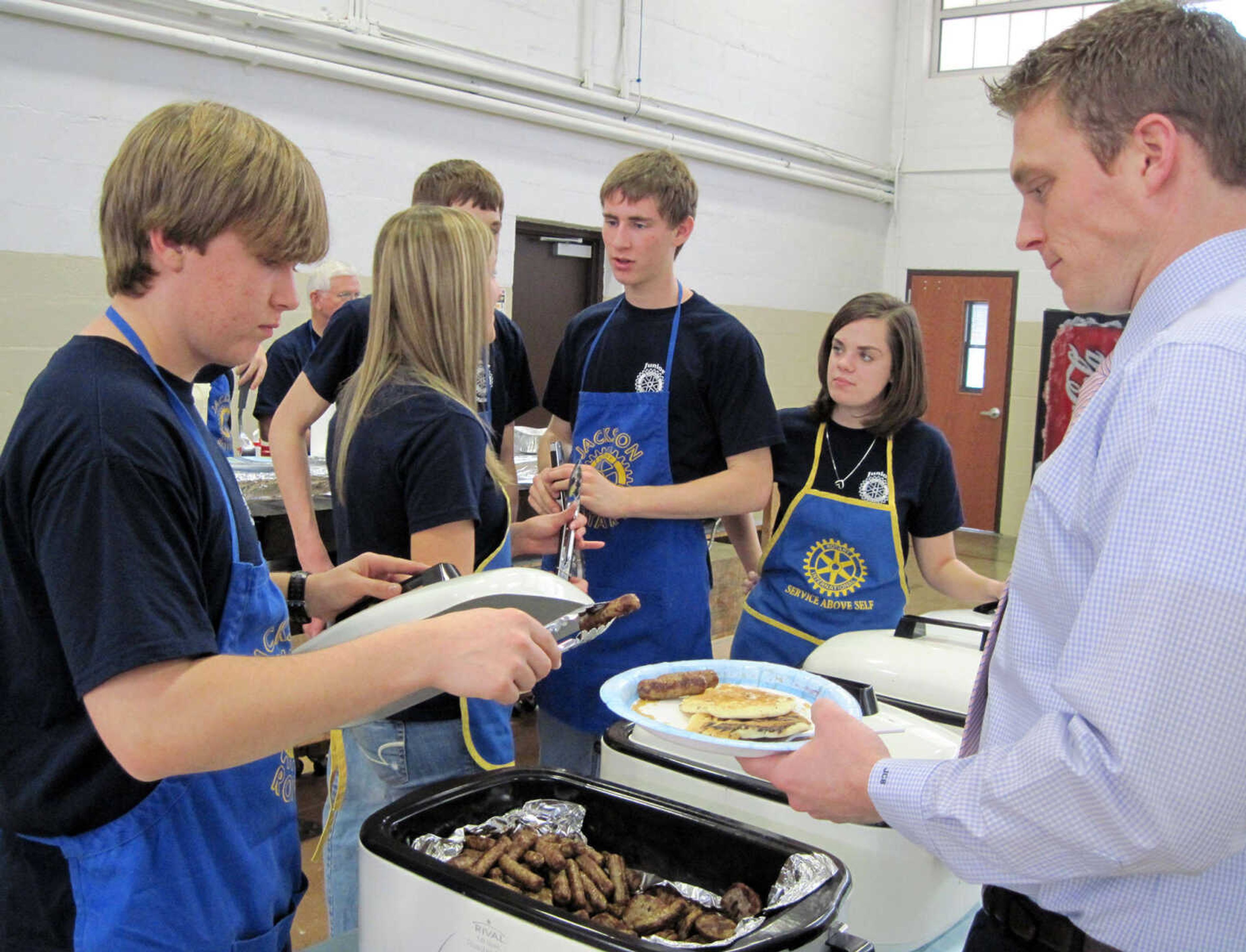 Rotary volunteer Matt Horst, left, serves pancakes to Jason Bandermann of Cape Girardeau.