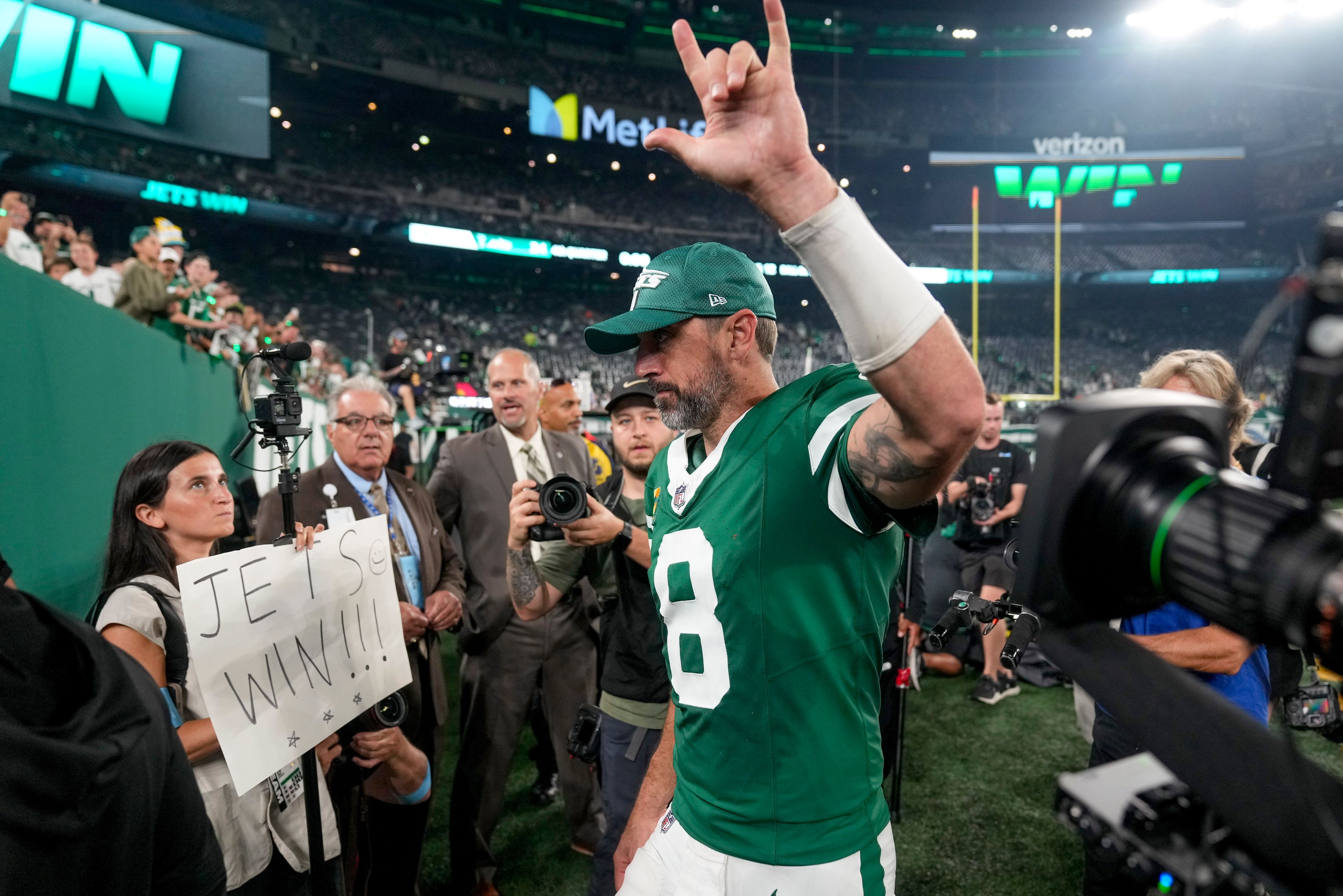 New York Jets quarterback Aaron Rodgers (8) motions to fans as he walks off the field after playing against the New England Patriots in an NFL football game, Thursday, Sept. 19, 2024, in East Rutherford, N.J. (AP Photo/Seth Wenig)