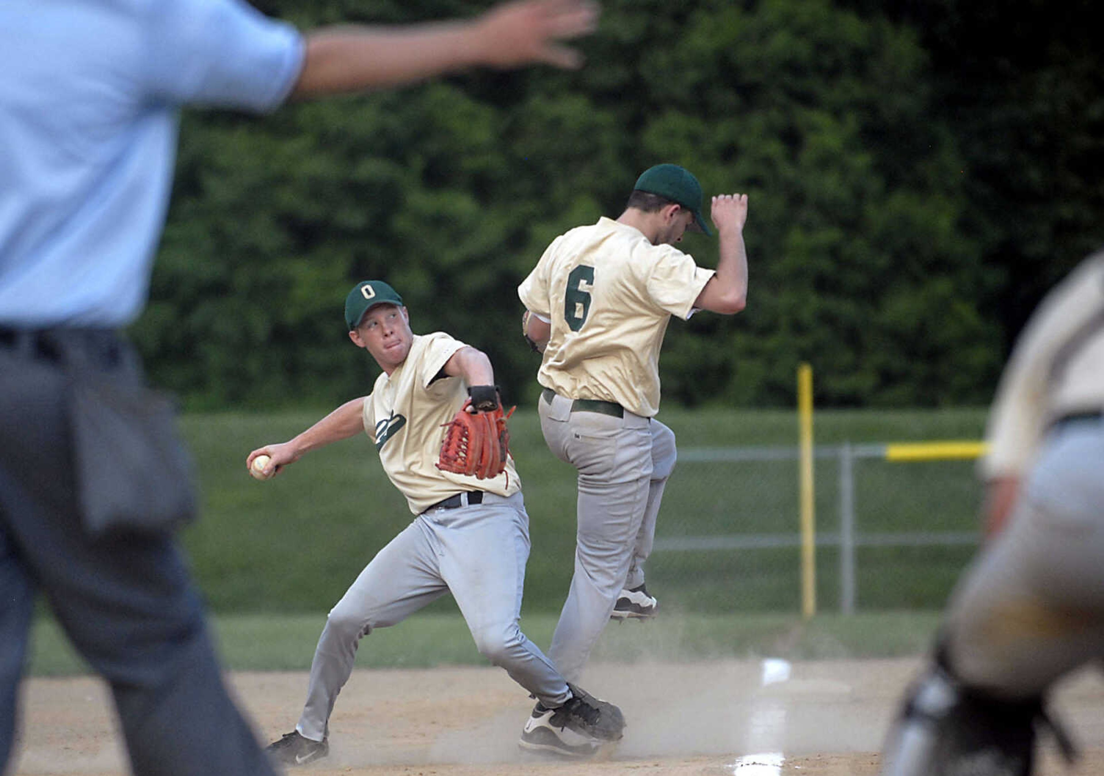 KIT DOYLE ~ kdoyle@semissourian.com 
New Madrid pitcher Josh Boese, left, grabs a grounder as third baseman Jay Singleton collides with him Monday evening, July 6, 2009, in a Senior Babe Ruth game at Jackson City Park.