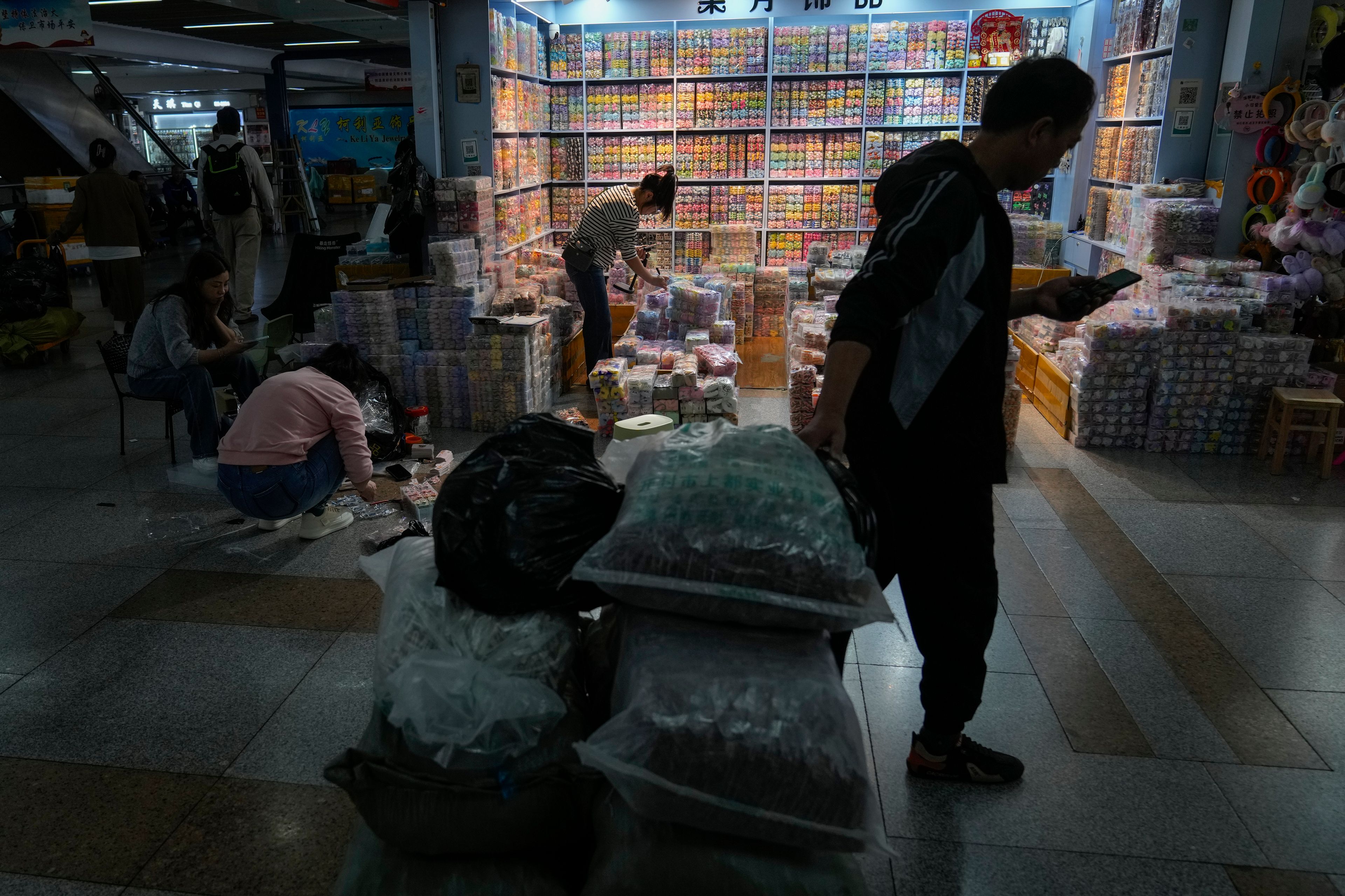 Workers pack fashion accessories at the Yiwu wholesale market in Yiwu, east China's Zhejiang province on Nov. 8, 2024. (AP Photo/Andy Wong)