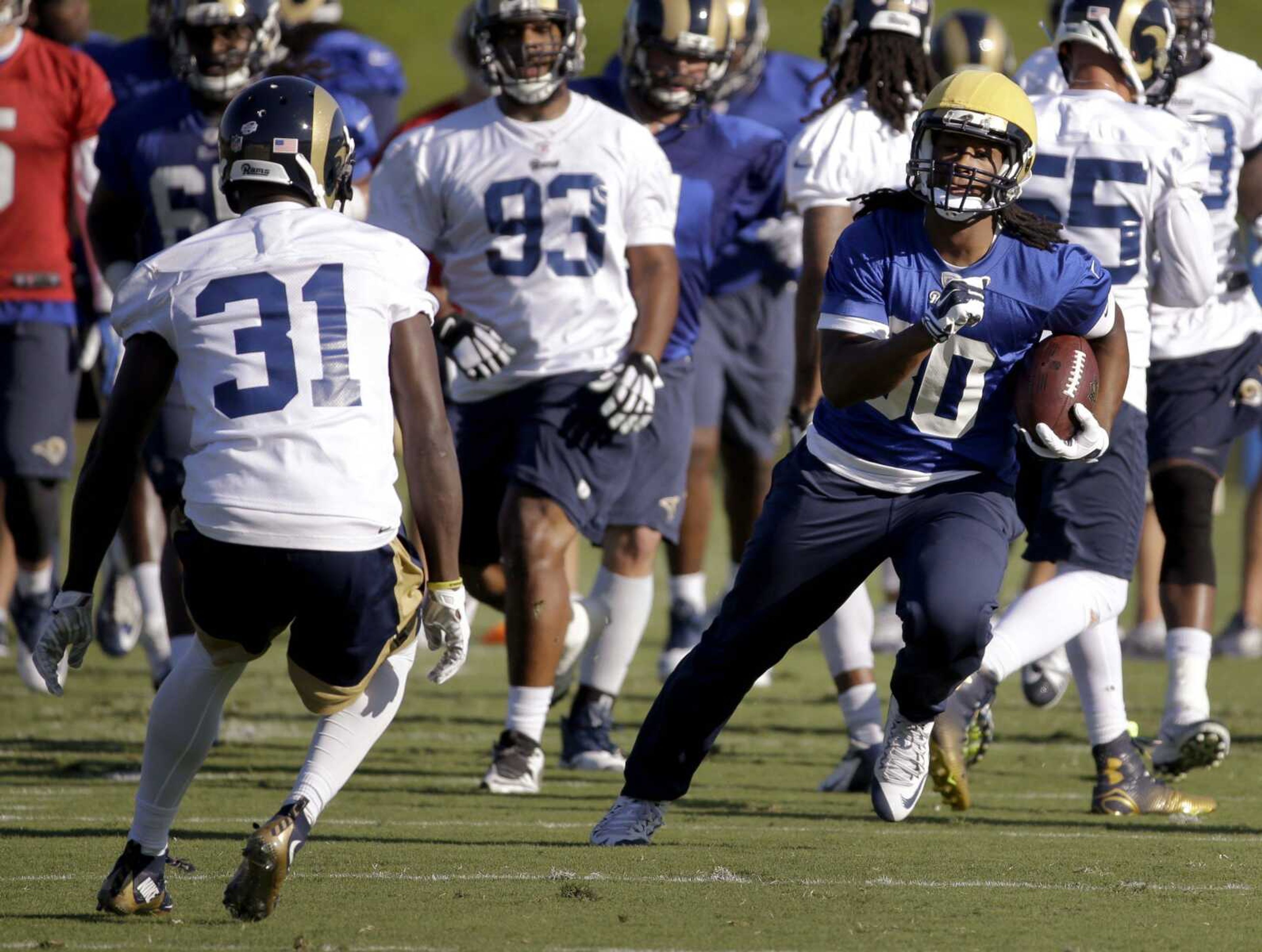 St. Louis Rams running back Todd Gurley, right, runs with the ball as safety Maurice Alexander (31) defends during training camp at the NFL football team's practice facility Tuesday, Aug. 25, 2015, in St. Louis. Gurley, who is rehabbing from left knee surgery that ended his college career, has been cleared to practice, but the 10th overall pick in the draft still won t play in the preseason. (AP Photo/Jeff Roberson)