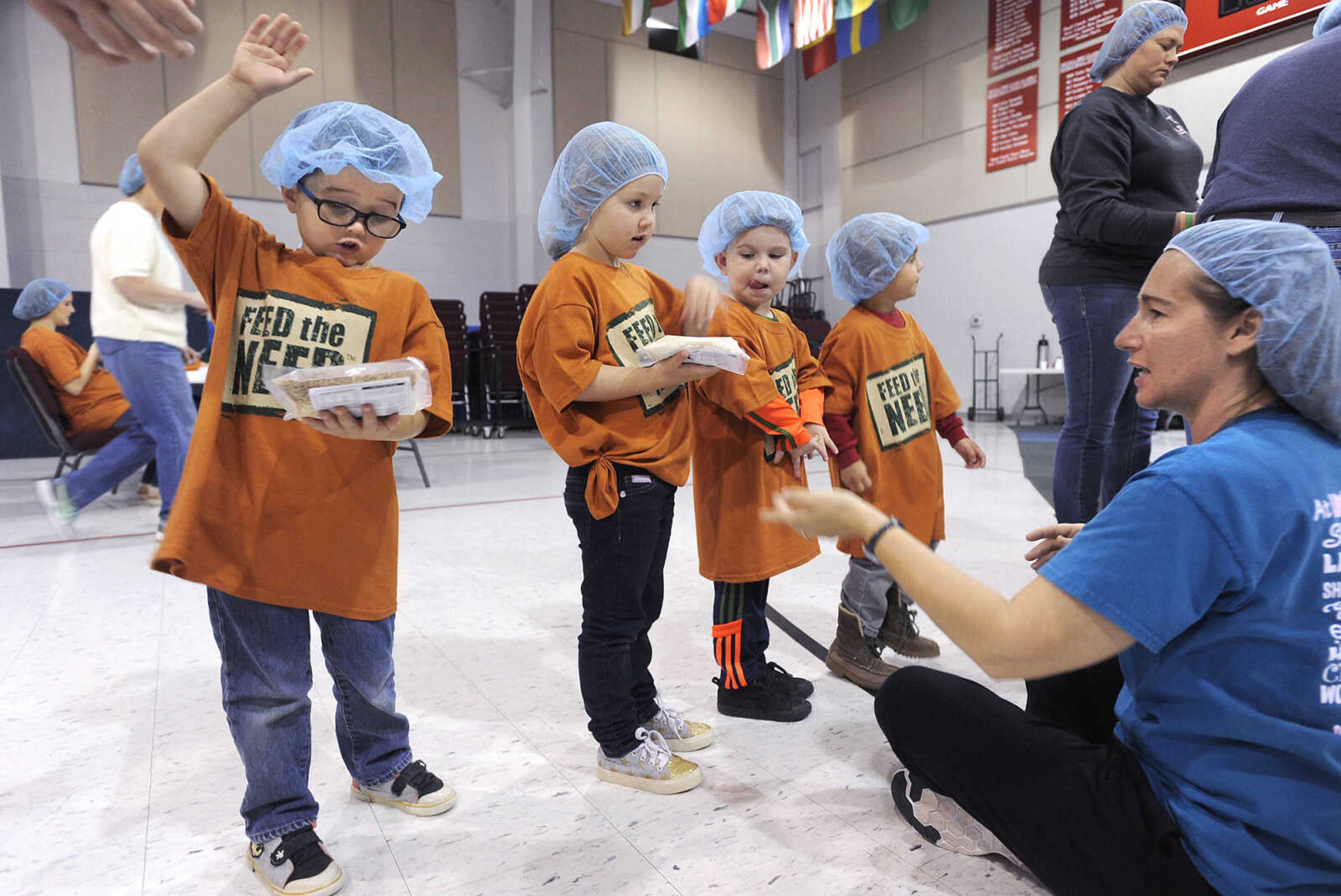 FRED LYNCH ~ flynch@semissourian.com
Denise Gartman supervises pre-kindergarteners in the meal-flattening line, from left, Benson Keesee, Sophie Lewis, Jeremiah Cook and Perry Kolwyck, during the Feed the Need meal-packing event Thursday, Nov. 17, 2016 at Eagle Ridge Christian School.