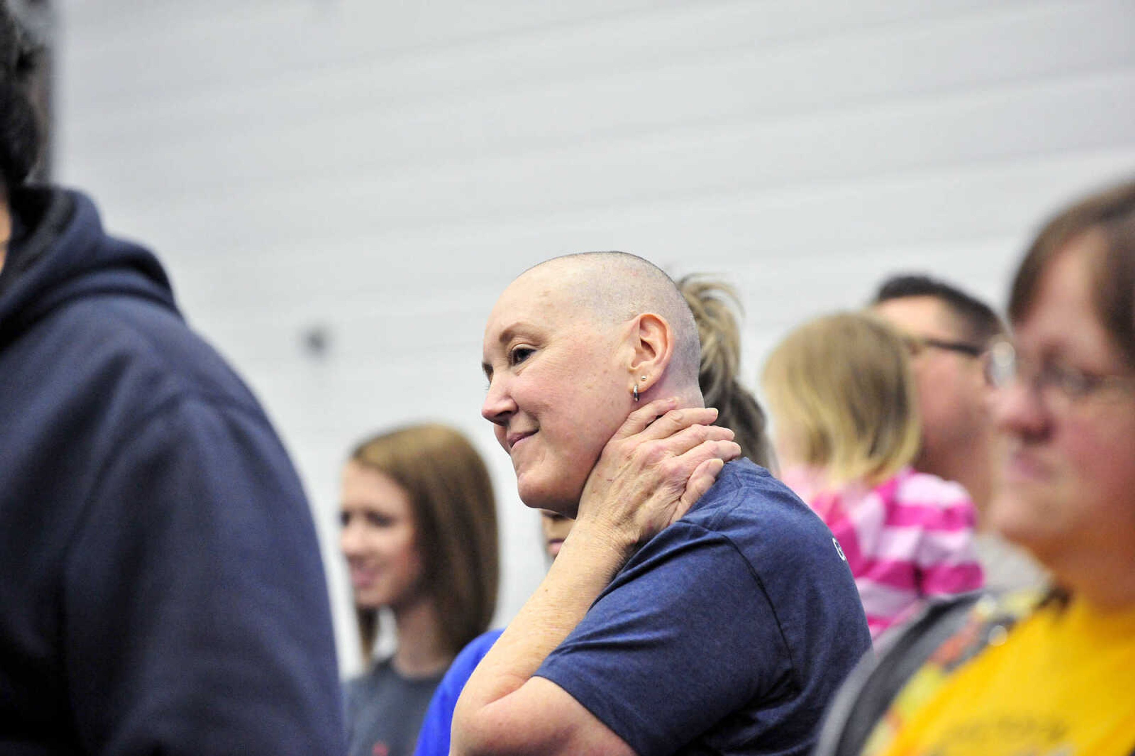 Terri Bogues watches others shave their heads on Saturday, March 4, 2017, during the St. Baldrick's Foundation fundraiser at Old Orchard CrossFit in Jackson.