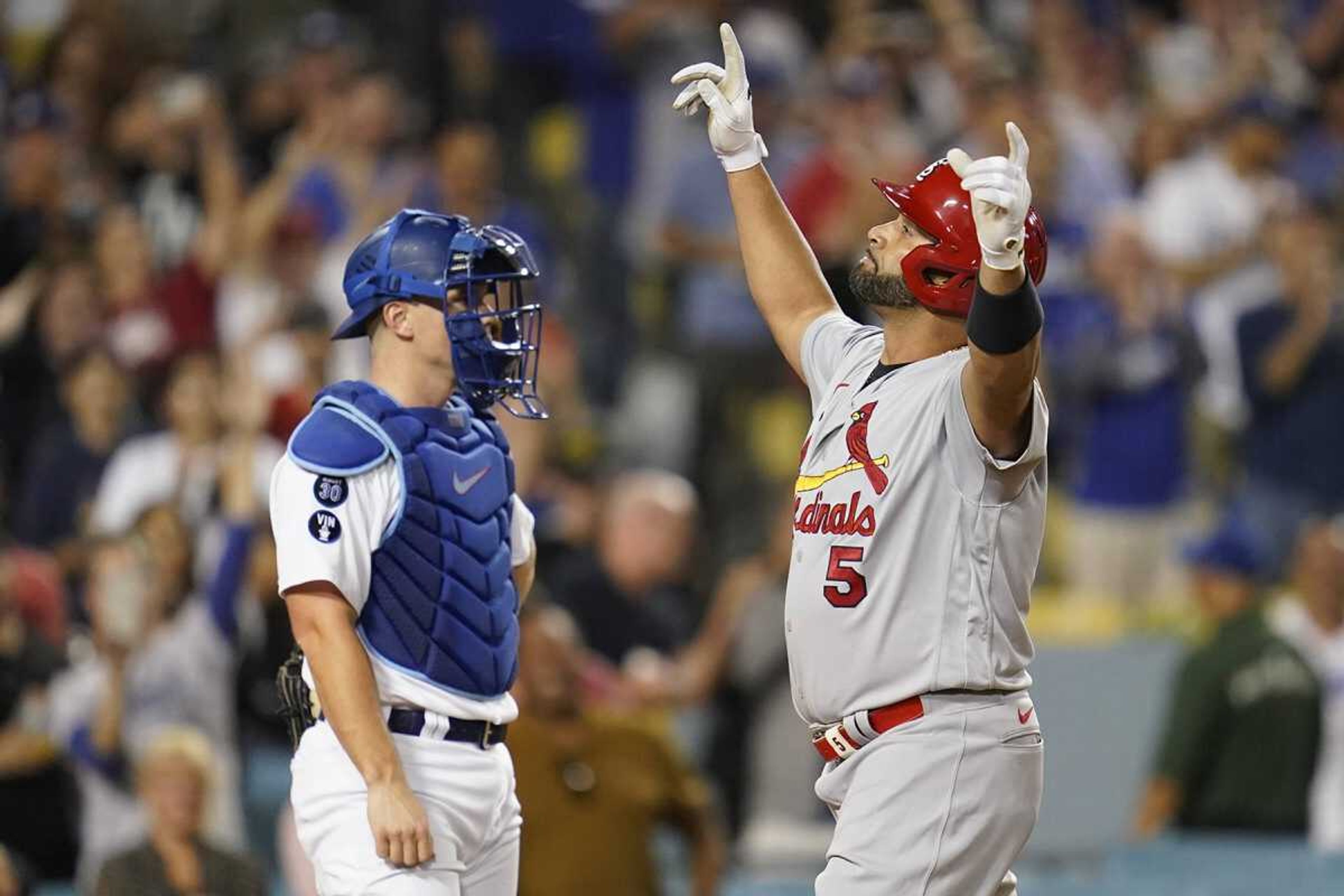 St. Louis Cardinals' Albert Pujols reacts as he crosses home plate after hitting a two-run home run during the third inning of a baseball game against the Los Angeles Dodgers in Los Angeles, Friday.