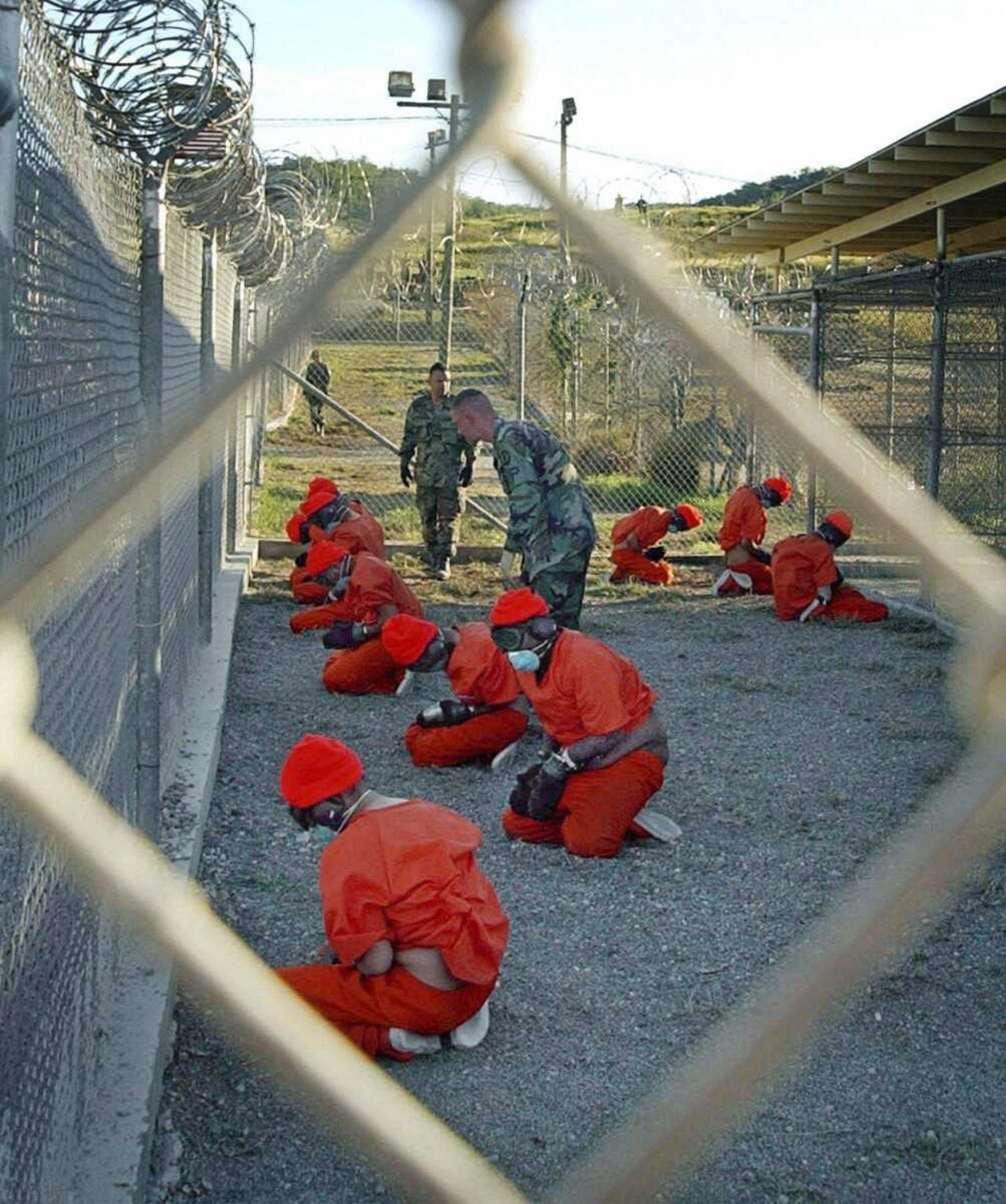 Associated Press file<br>In this Jan. 11, 2002, photo released by the Department of Defense, detainees wearing orange jump suits sit in a holding area as military police patrol at Guantanamo Bay U.S. Naval Base in Cuba. President Obama began overhauling U.S. treatment of terror suspects, signing orders Thursday to close the Guantanamo Bay detention center.