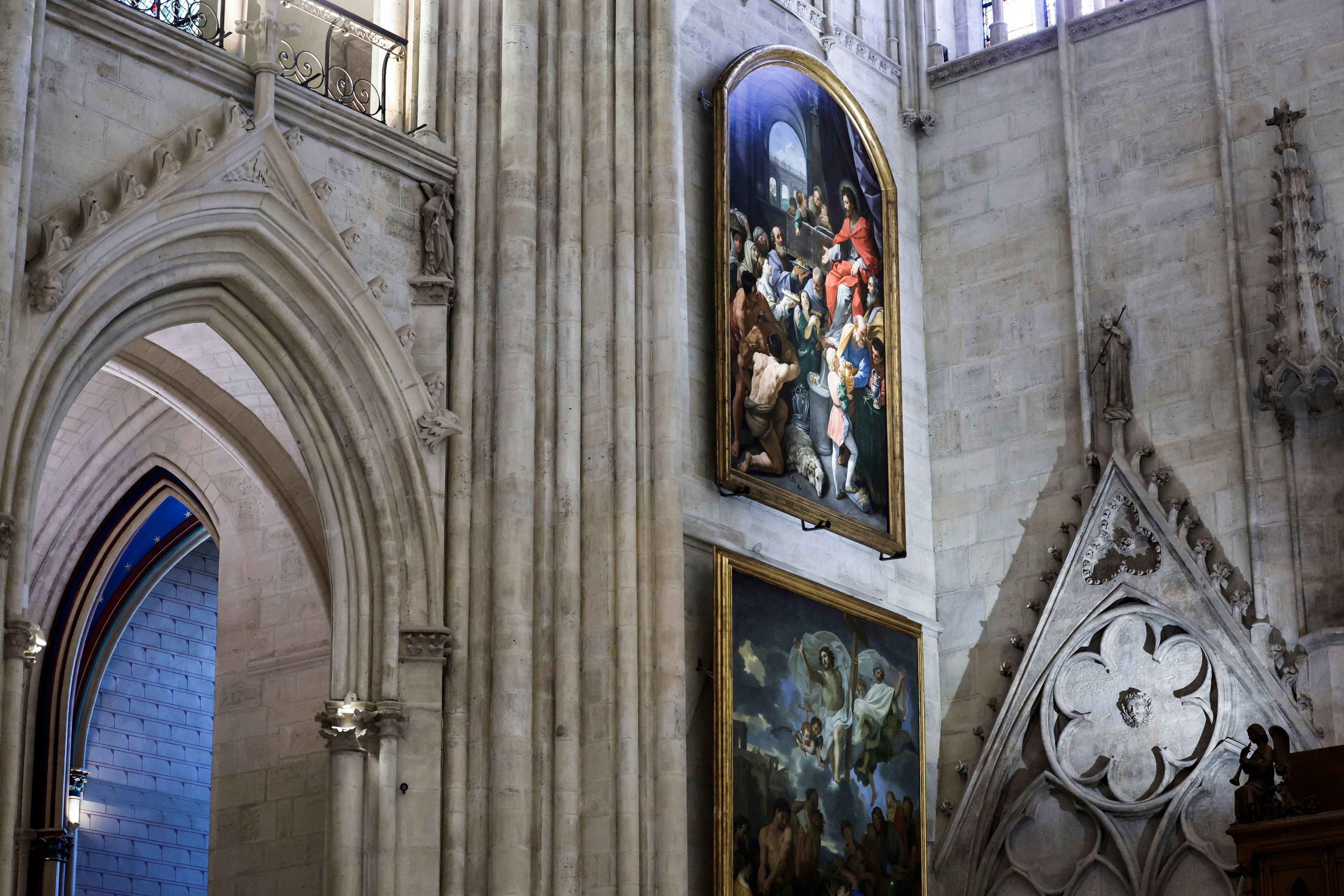 Paintings are seen inside Notre-Dame de Paris cathedral while French President Emmanuel Macron visits the restored interiors of the monument, Friday Nov. 29, 2024, in Paris. (Stephane de Sakutin, Pool via AP)