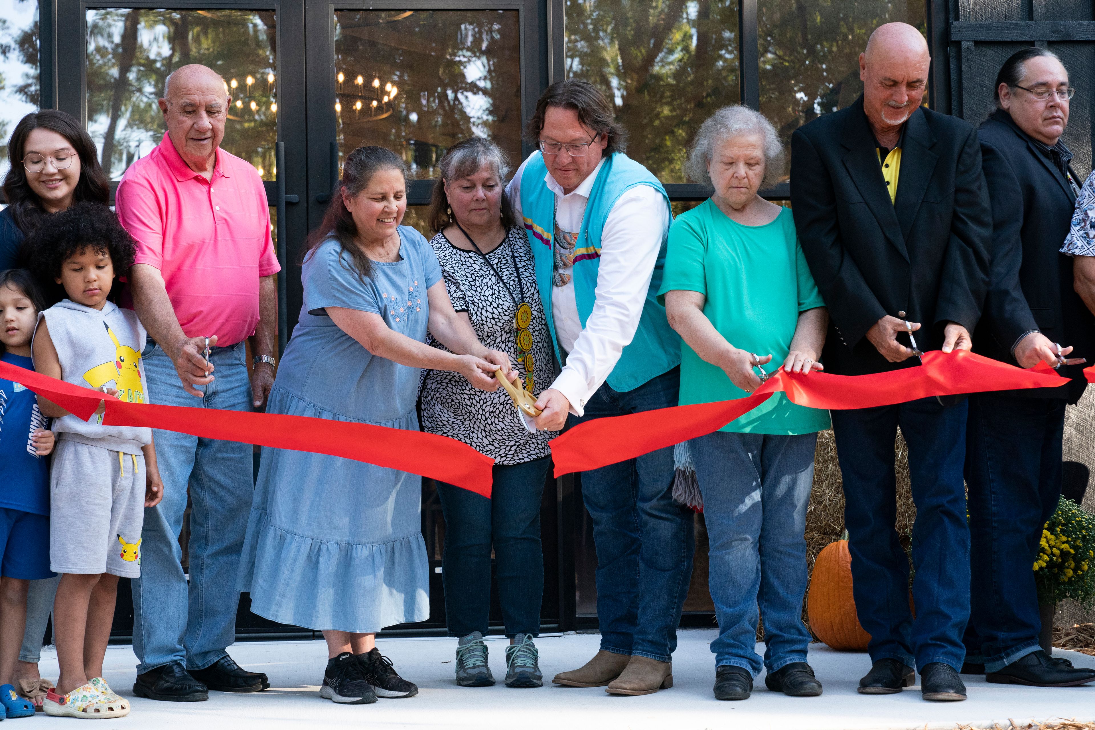 Members of the Shawnee Tribe cut the ribbon at the Shawnee Language Center on Friday, September 20, 2024 in Miami, Okla.. (AP Photo/Nick Oxford)