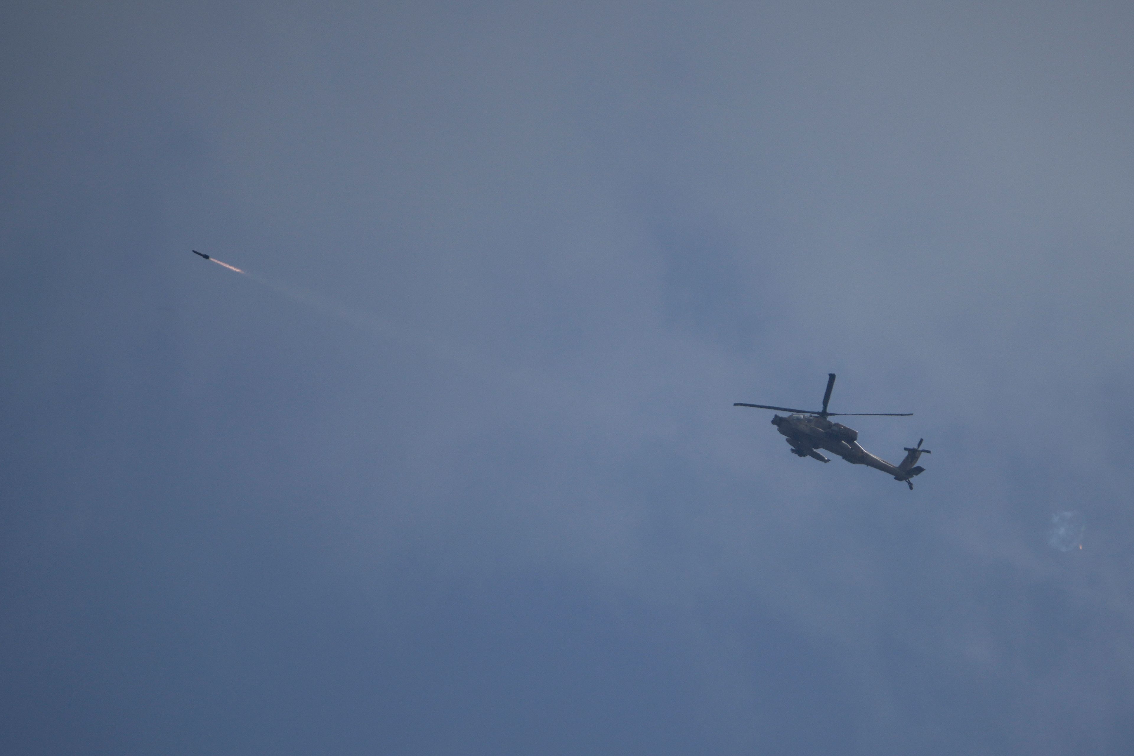 An Israeli Apache helicopter fires a missile towards southern Lebanon as seen from northern Israel, Tuesday, Oct. 1, 2024. (AP Photo/Leo Correa)