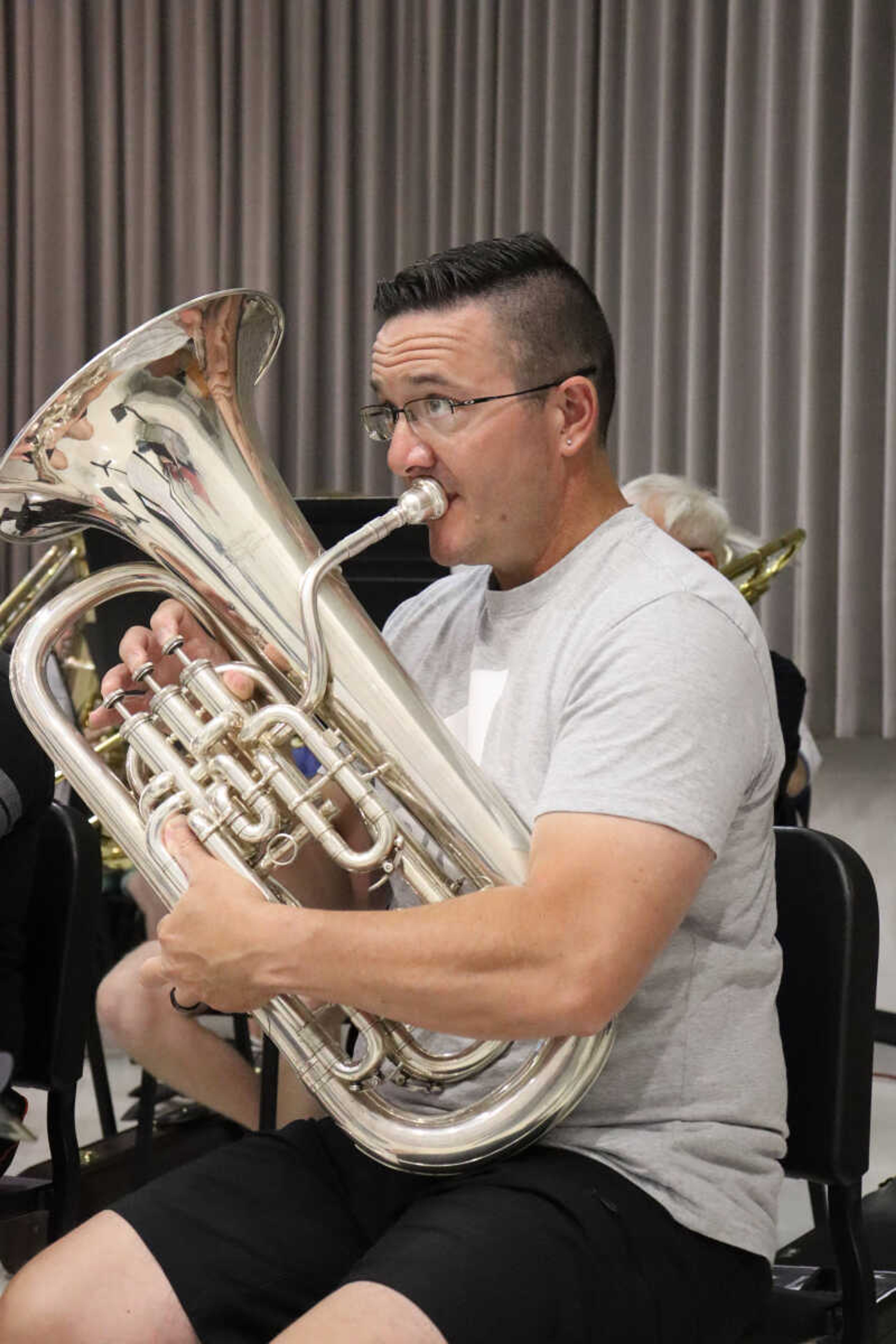 Tom Broussard playing the baritone while following the arrangement in practice with the Jackson Municipal Band on Tuesday.