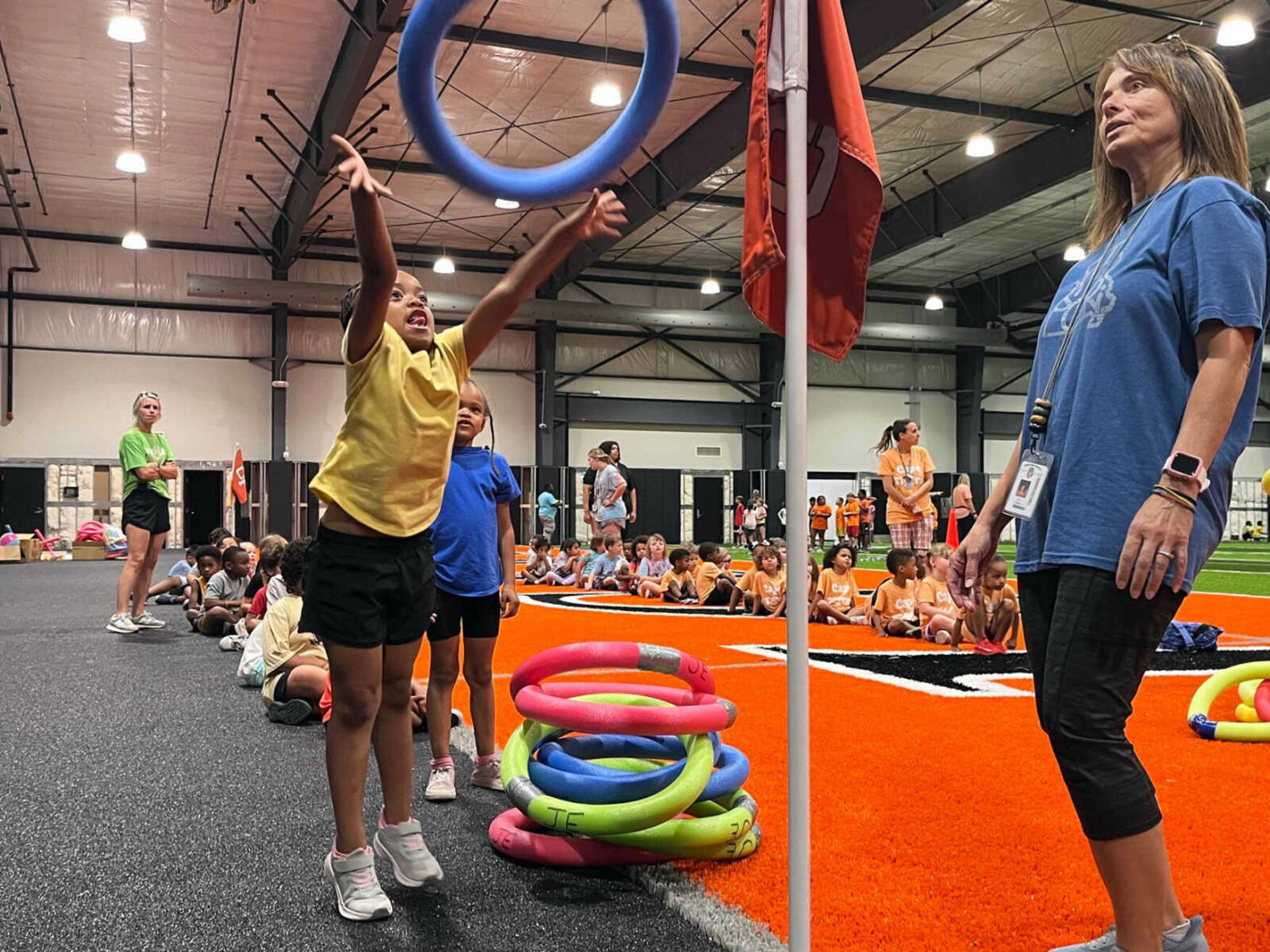 An elementary student participates in the ring toss portion of an obstacle course during the final day of summer school Friday, June 7, at Cape Central High School in Cape Girardeau.