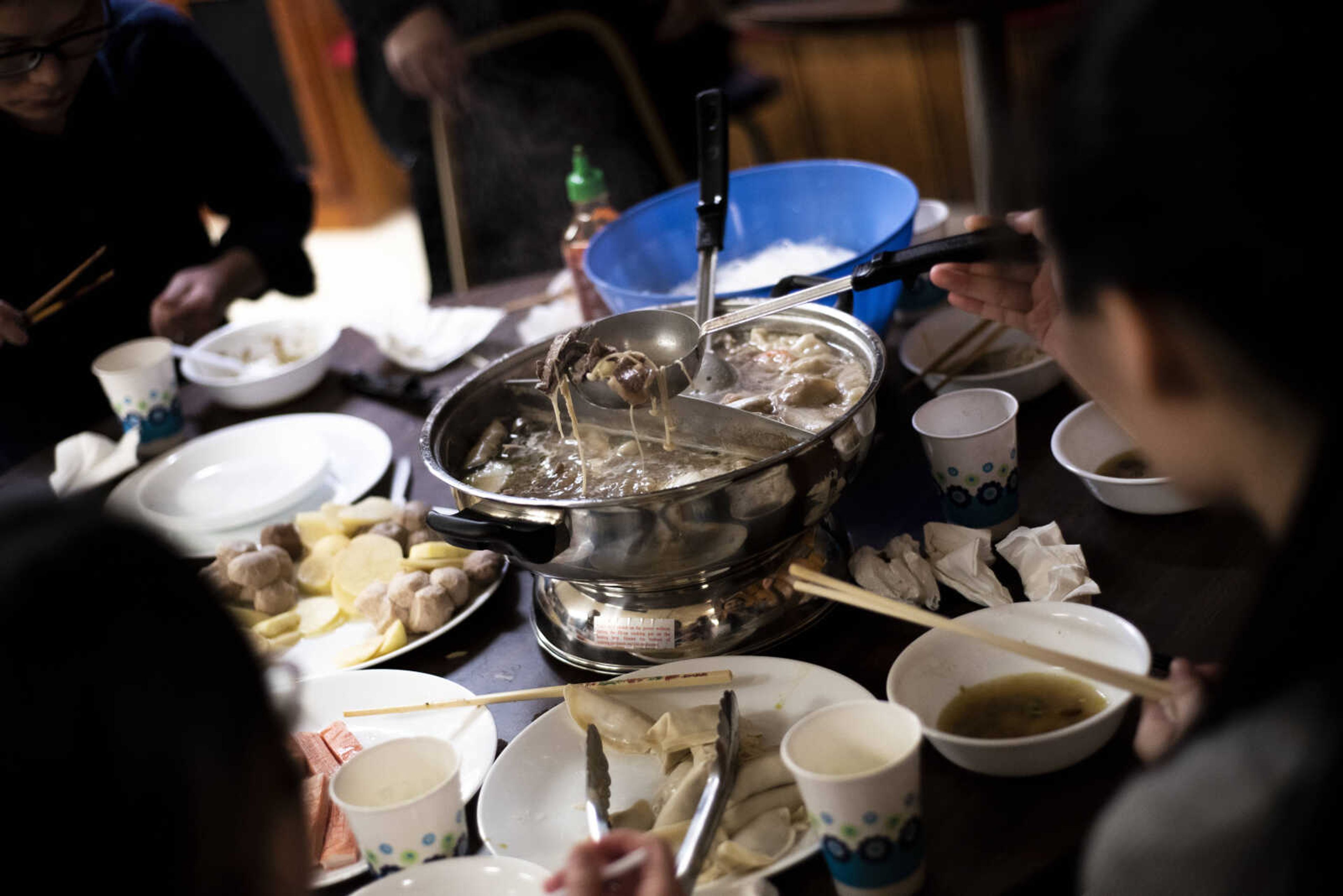 Students enjoy a hotpot-style, traditional Chinese meal with vegetables and meat before their Bible study Friday, March 8, 2019, at the Southeast Missouri State University's Baptist Student Center in Cape Girardeau.