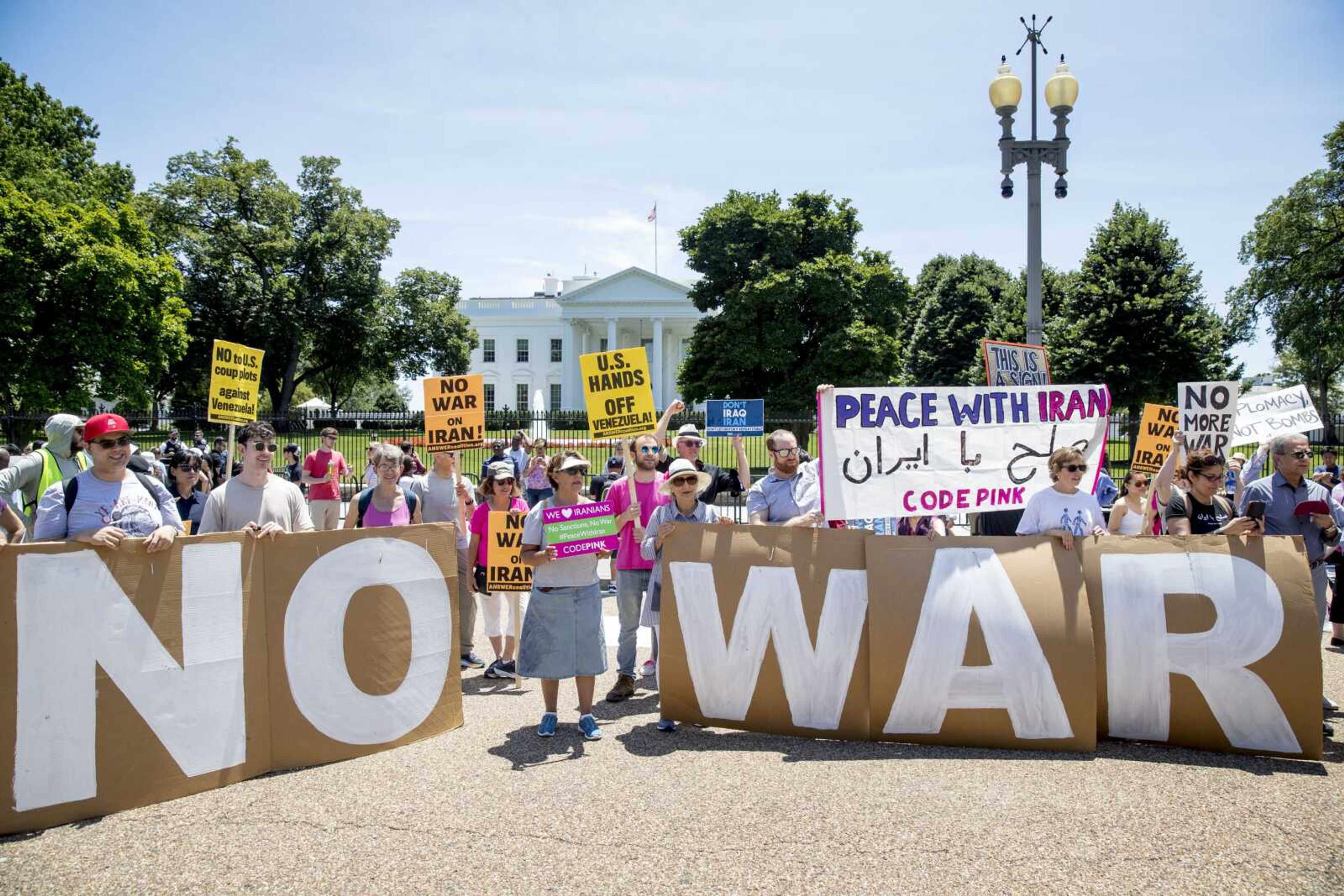 Members of the ANSWER Coalition hold an anti-war with Iran rally Sunday outside of the White House in Washington.