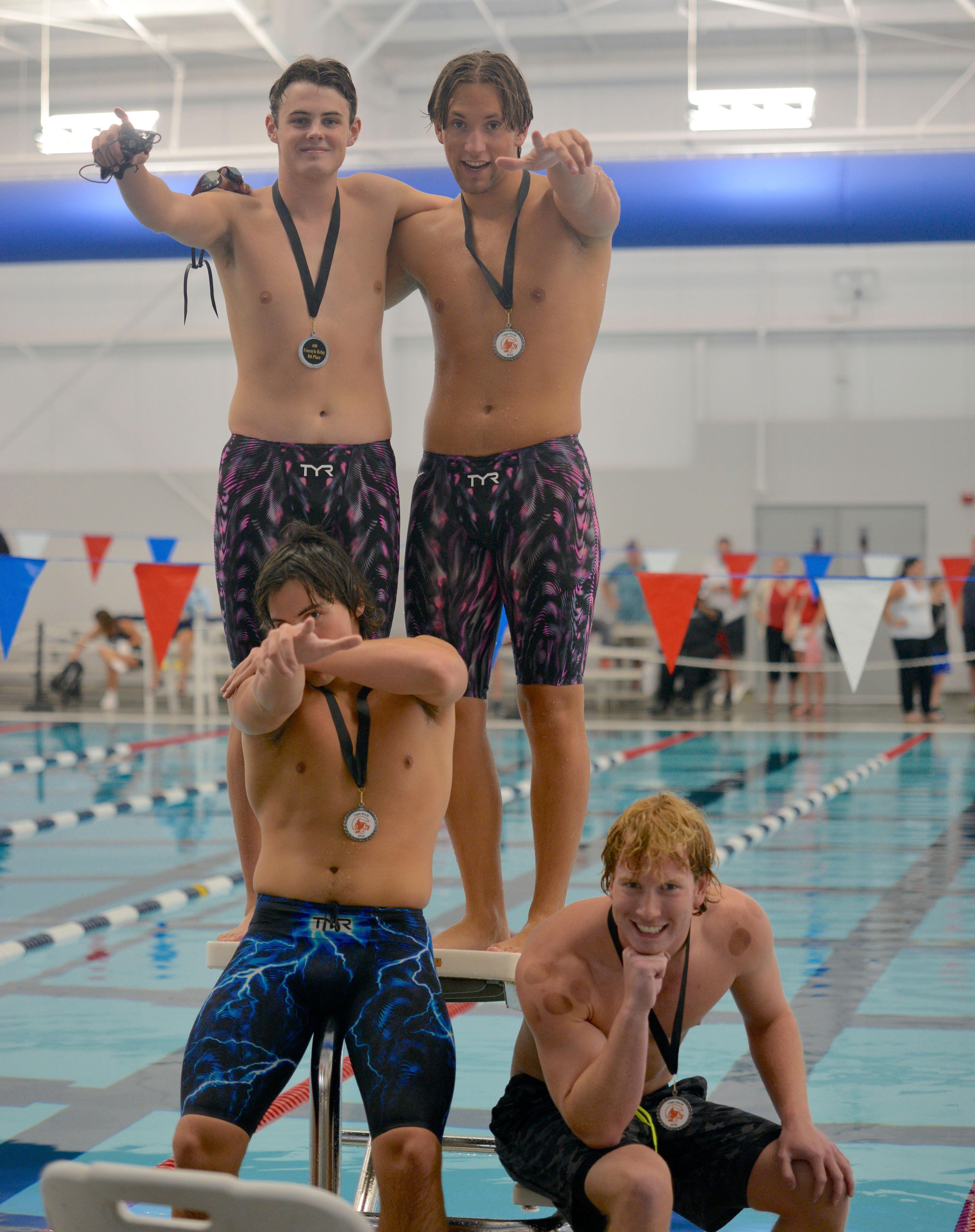 The Poplar Bluff 400-yard freestyle relay of Cyrus Sagharichi, bottom left, Owen McDaniel, top left, Connor Wiggs, top right, and Henry Duncan, pose after winning eighth place at Cape Rock on Saturday, Sept. 14, at the Cape Aquatic Center.