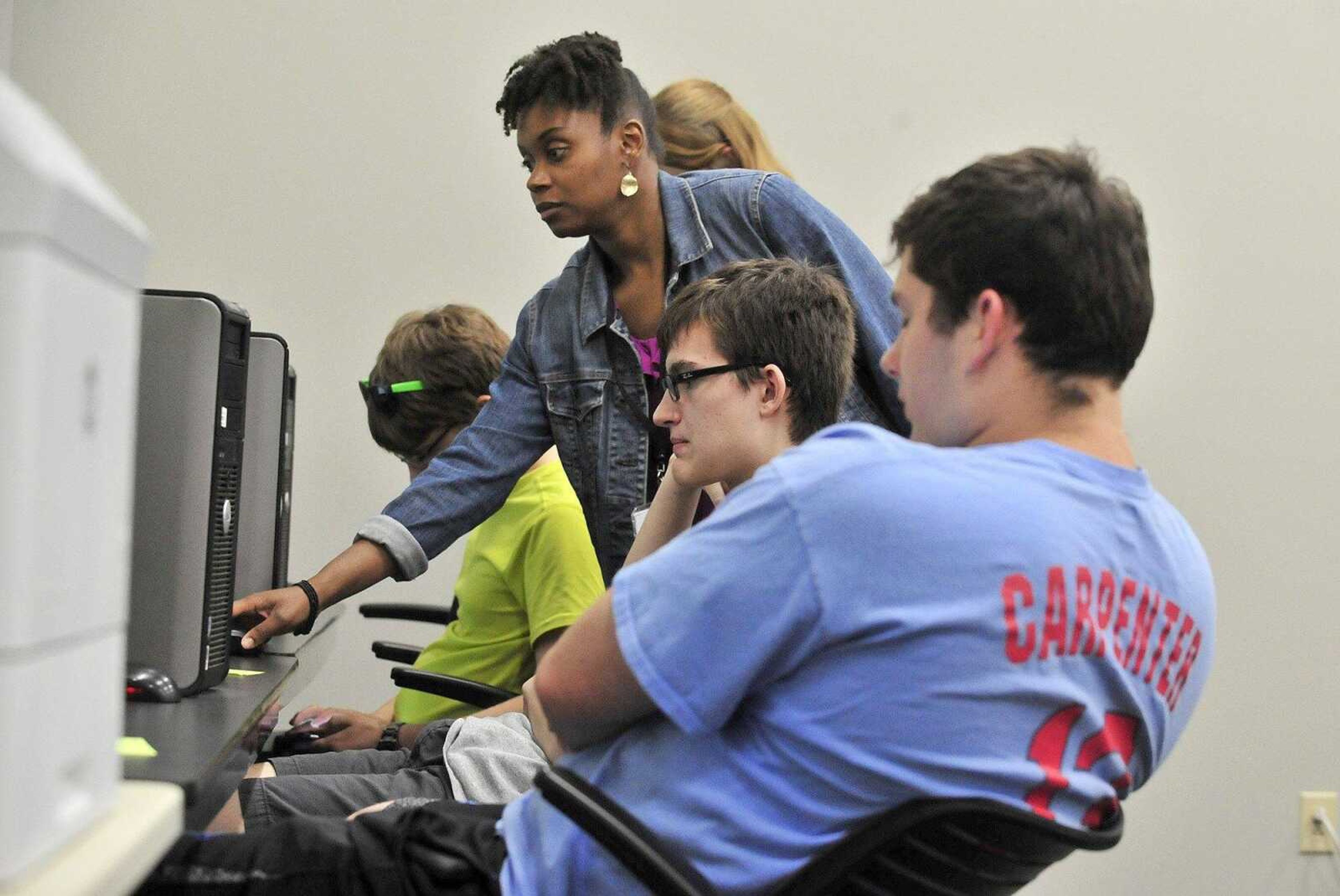 Marnae Foster, and intech specialist with the St. Louis County Missouri Career Center, helps Kevin Schuller, second from right, and Seamus Dolhick with their resumes as part of The Tailor Institute's program, Project Life Experience, on Wednesday, May 31, 2017, in St. Ann, Missouri.