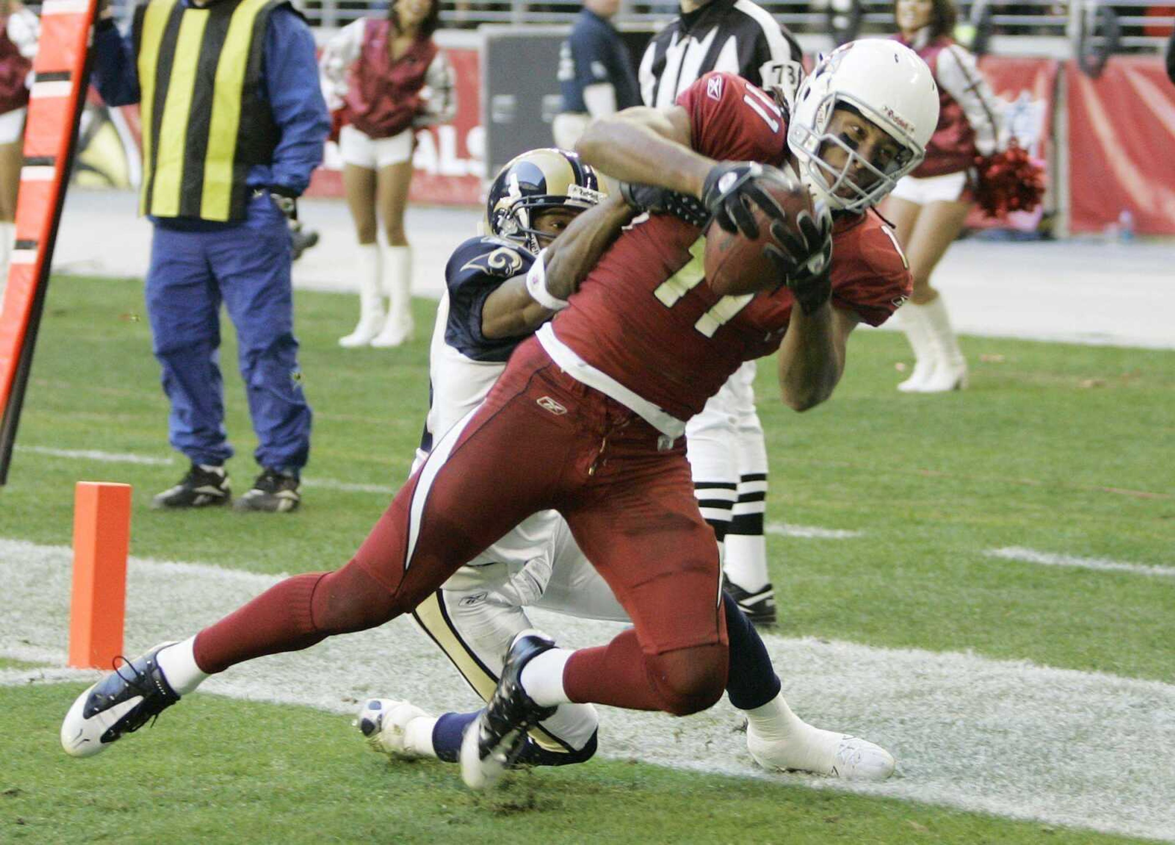 Arizona Cardinals wide receiver Larry Fitzgerald, right, catches a touchdown pass against St. Louis Rams cornerback Fakhir Brown, left, in the second quarter of an NFL football game Sunday, Dec. 30, 2007 in Glendale, Ariz.  (AP Photo/Ross D. Franklin)