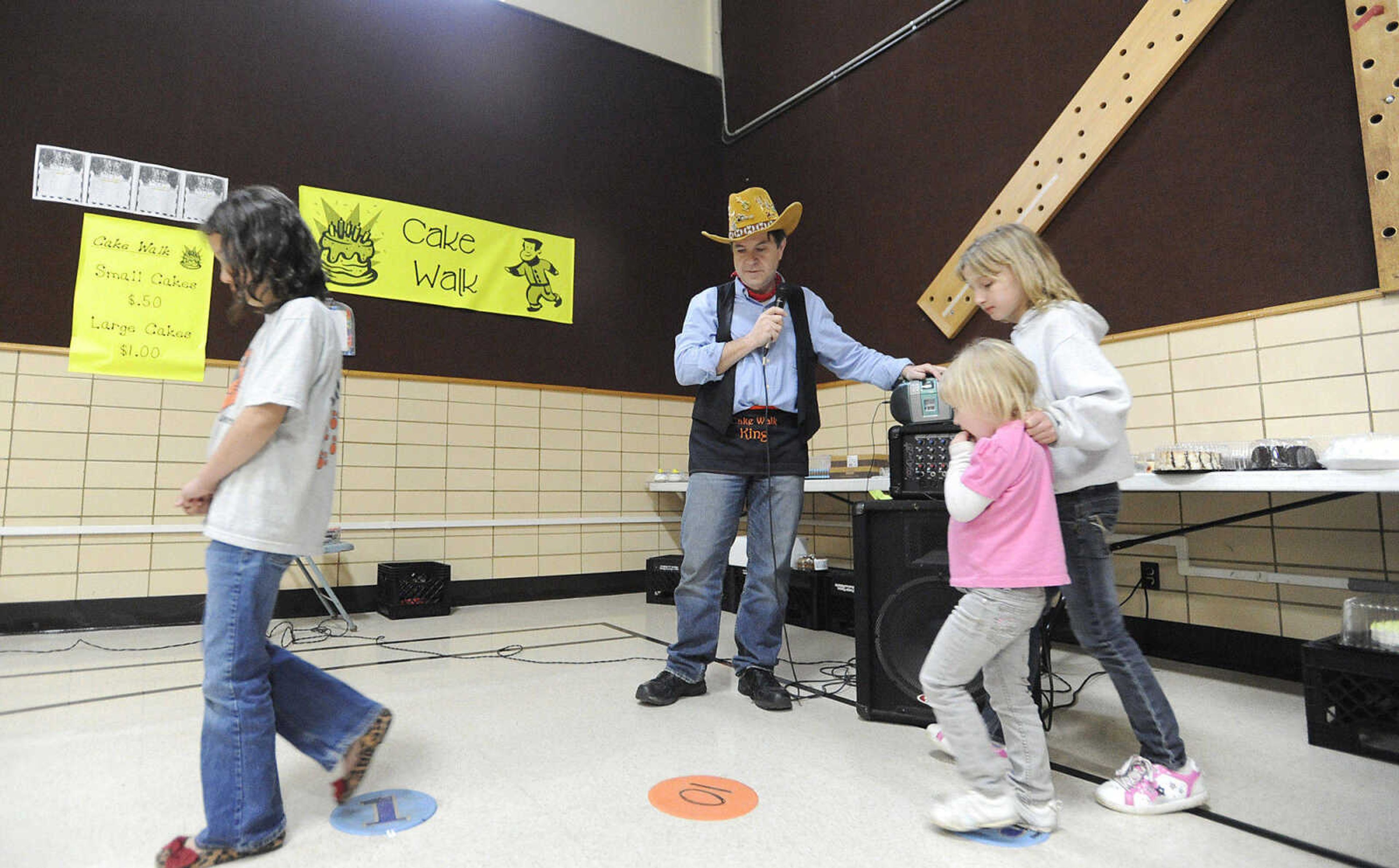 Principal Mark Cook officiates the cake walk during the Jefferson Elementary Chili Dinner Friday night. Cook is retiring after this year.