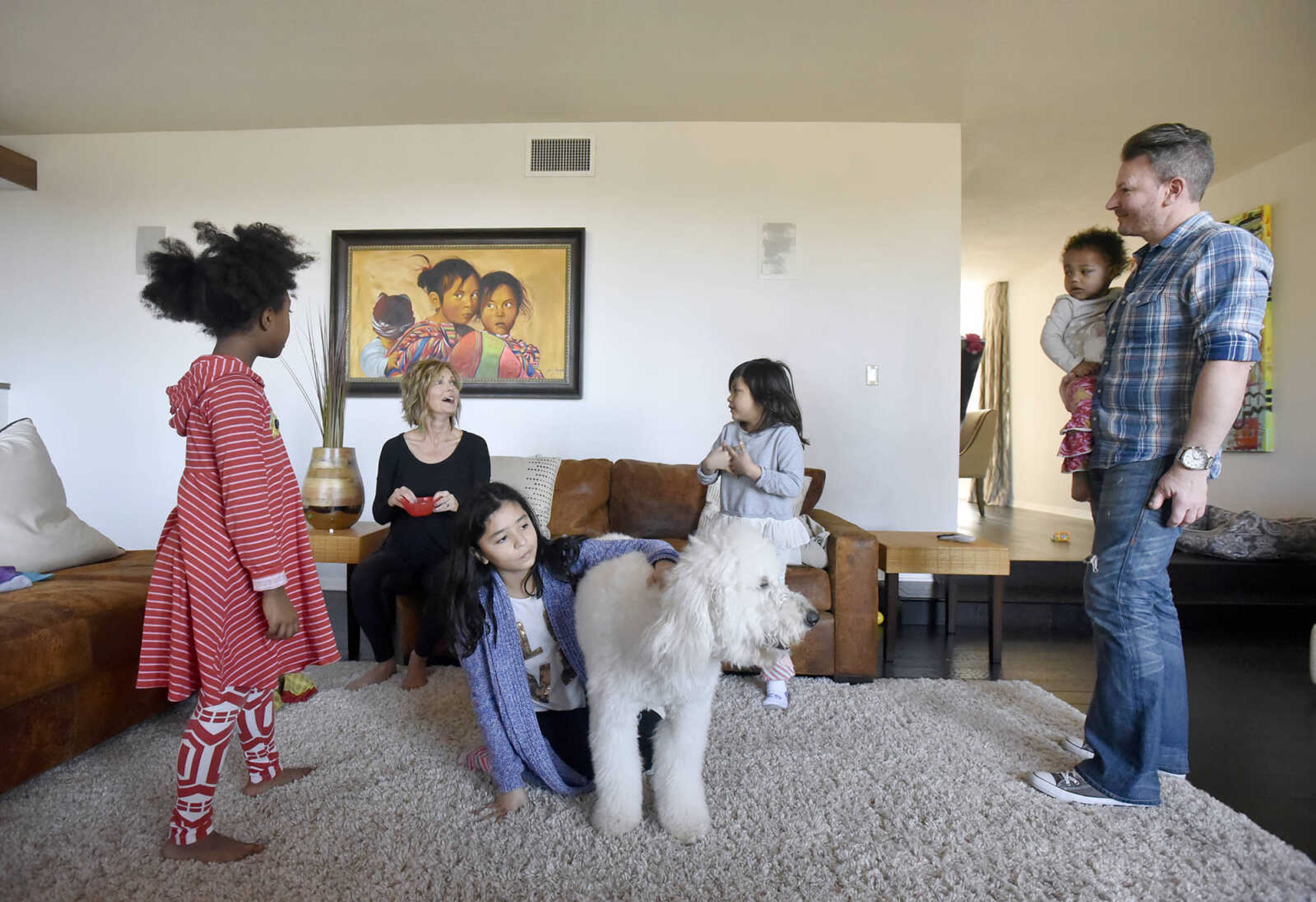 Pictured from left to right, Solie, 8, Chantelle, Bianca, 10, Marley the family dog, Ari, 5, Lennyx, 1, and Eric Becking hangout in the family room on Saturday, Jan. 28, 2017, at the Becking's Cape Girardeau home.