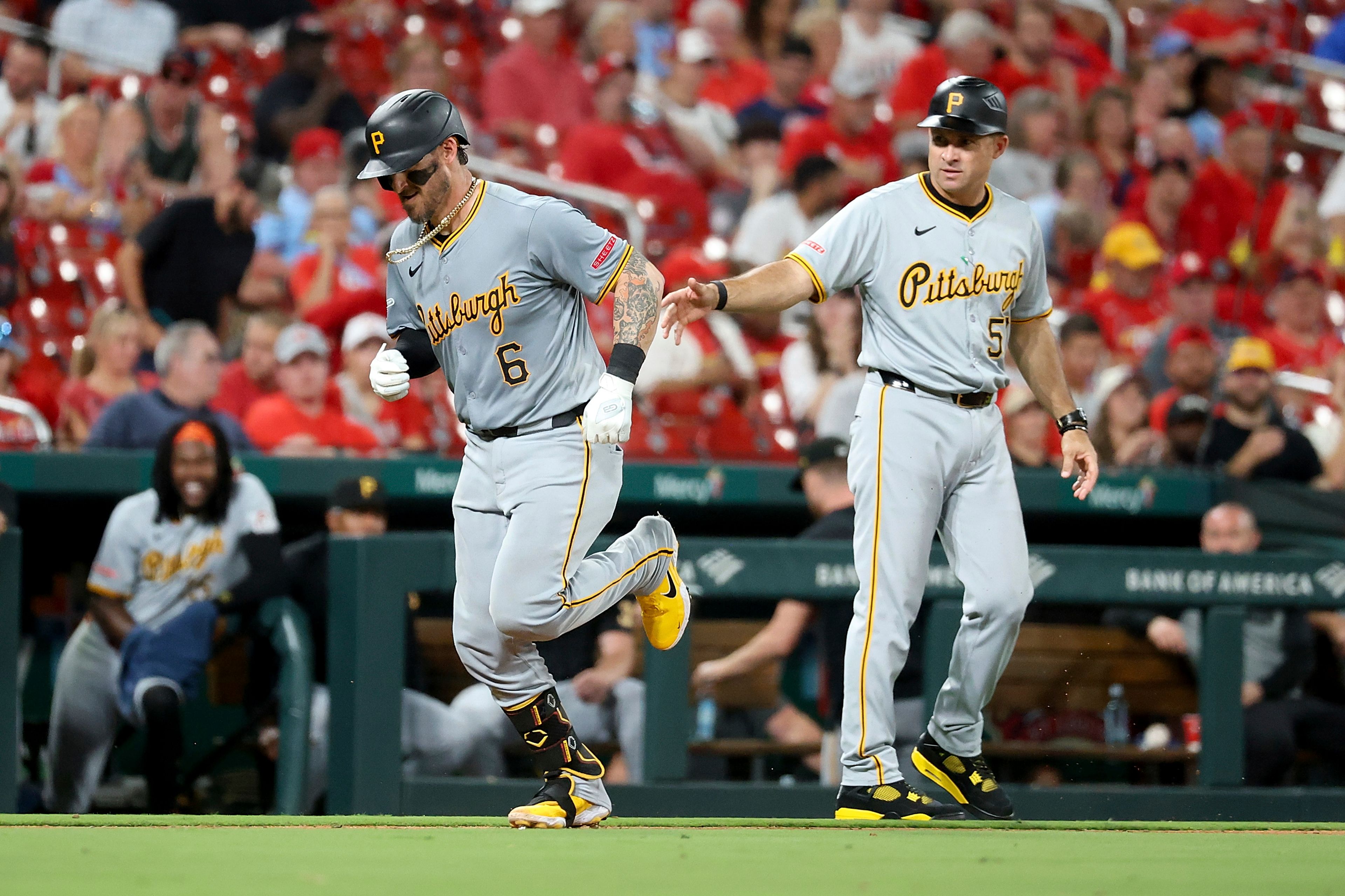 Pittsburgh Pirates' Yasmani Grandal, left, is congratulated by third base coach Mike Rabelo, right, as he runs the bases after hitting a solo home run during the seventh inning against the St. Louis Cardinals, Thursday, Sept. 19, 2024, in St. Louis. (AP Photo/Scott Kane)