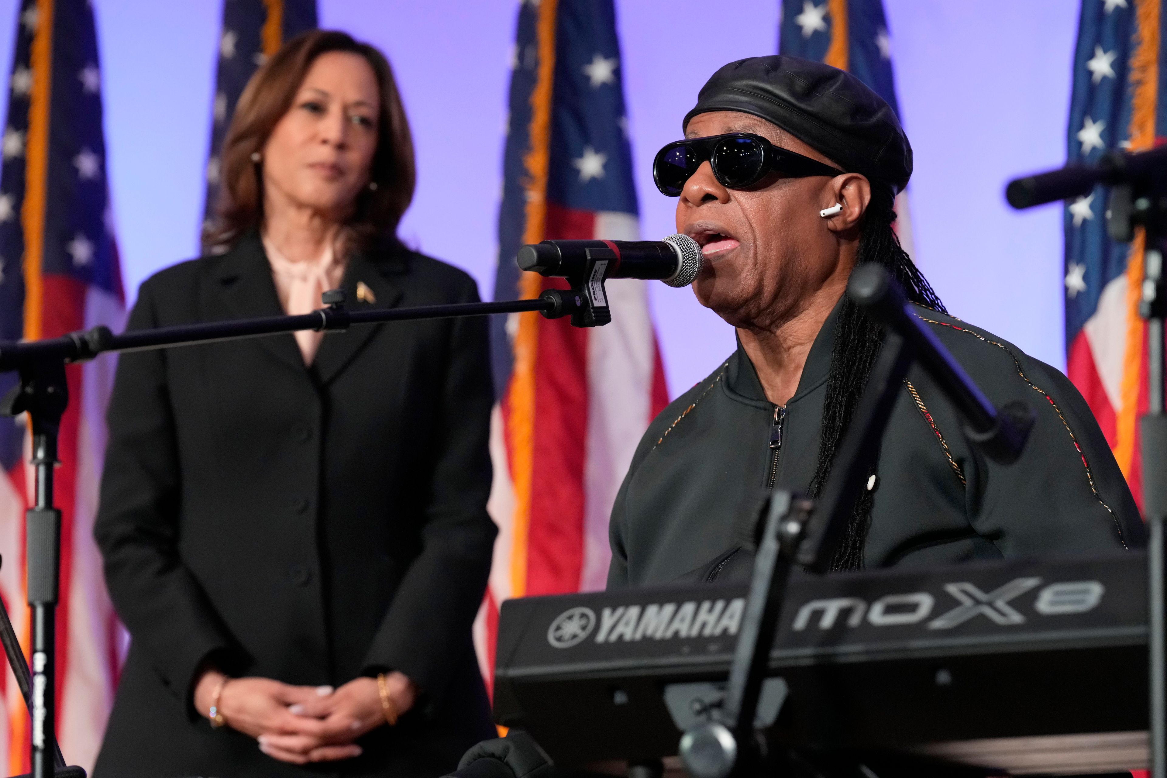 Democratic presidential nominee Vice President Kamala Harris looks on as Stevie Wonder sings "Happy Birthday" to Harris during a church service and early vote event at Divine Faith Ministries International, Sunday, Oct. 20, 2024, in Jonesboro, Ga. (AP Photo/Jacquelyn Martin)