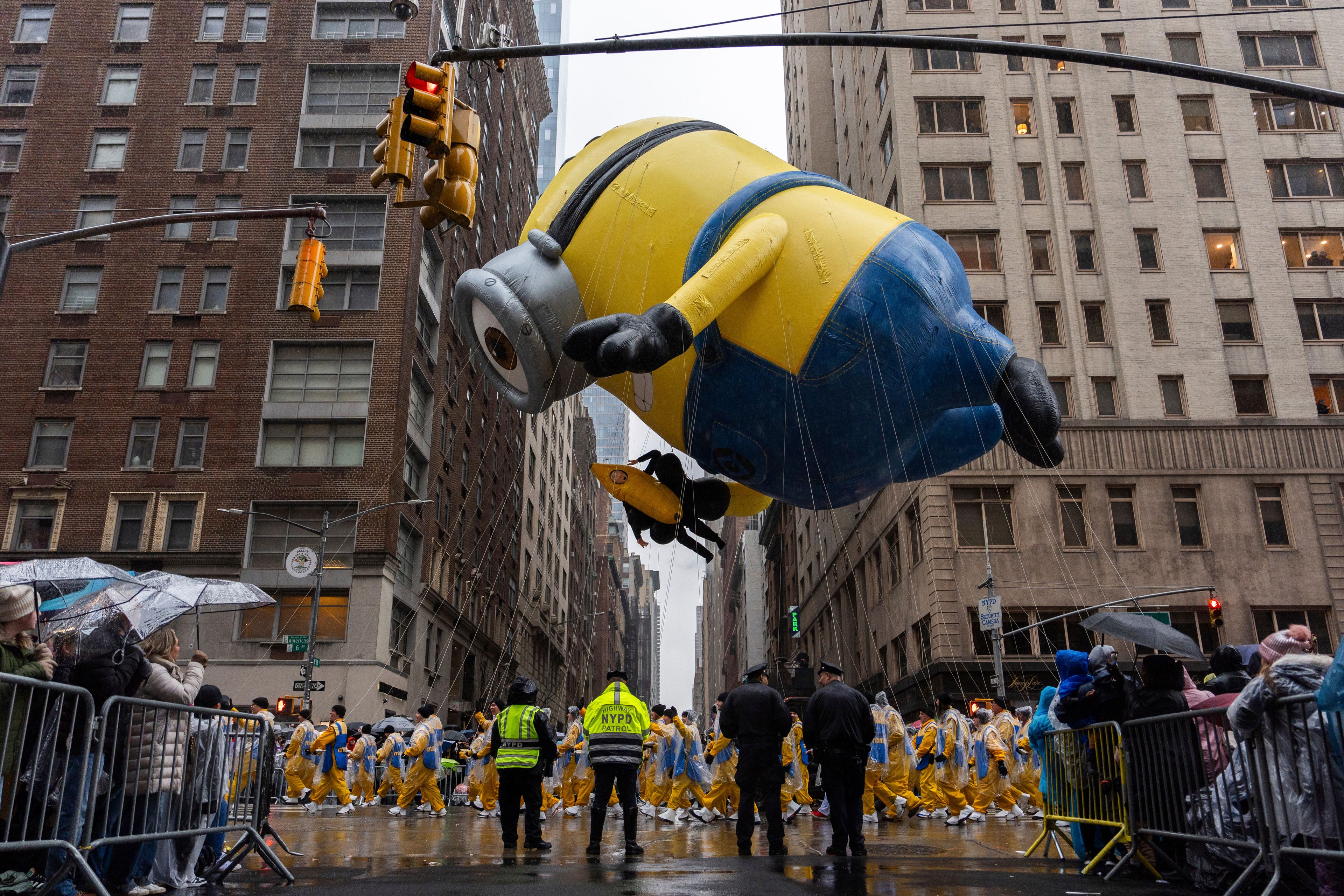 Handlers pull the Stuart the Minion balloon down Sixth Avenue during the Macy's Thanksgiving Day Parade, Thursday, Nov. 28, 2024, in New York. (AP Photo/Julia Demaree Nikhinson)