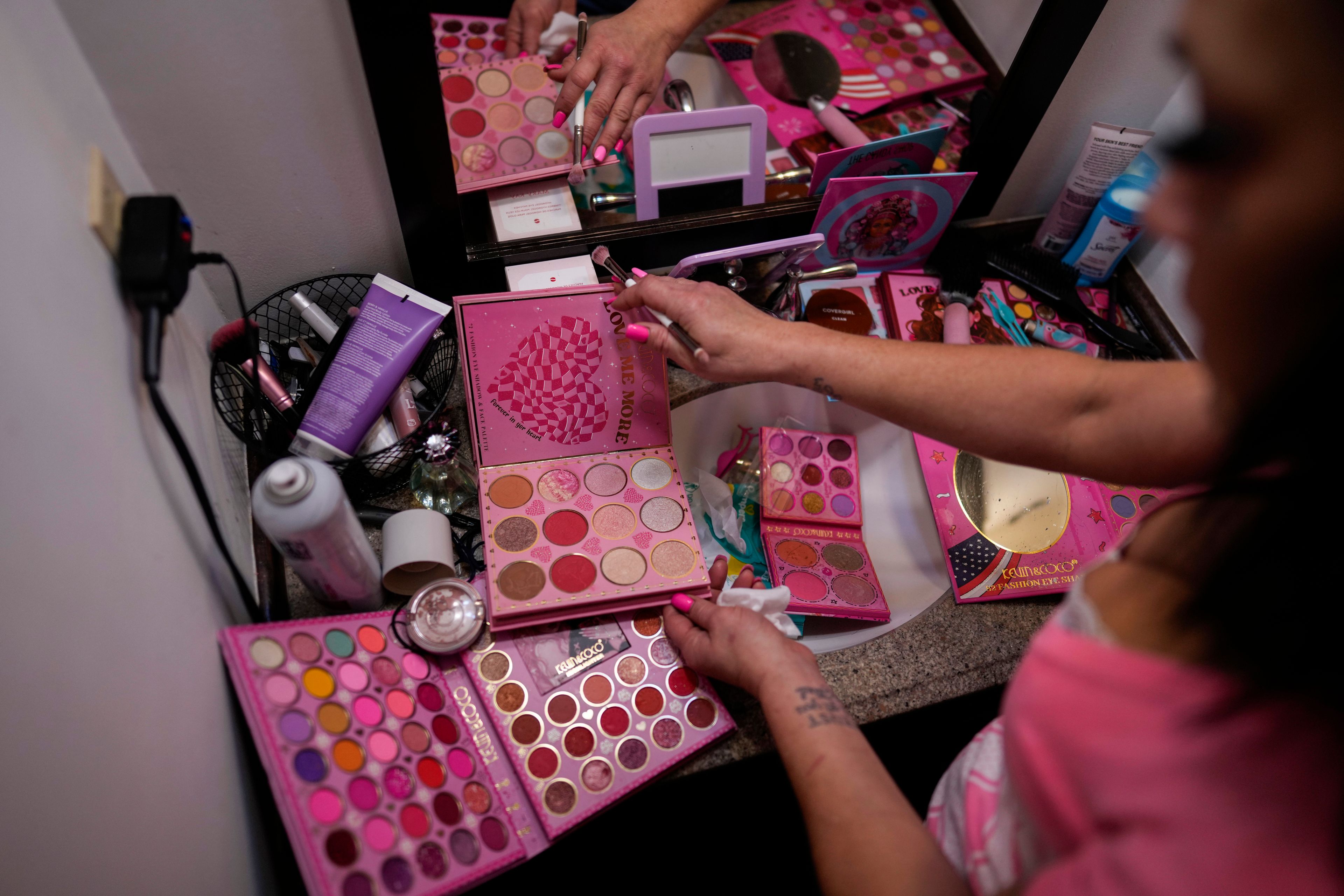 April Youst does her makeup in her West Virginia home, Wednesday, Oct. 9, 2024. (AP Photo/Carolyn Kaster)