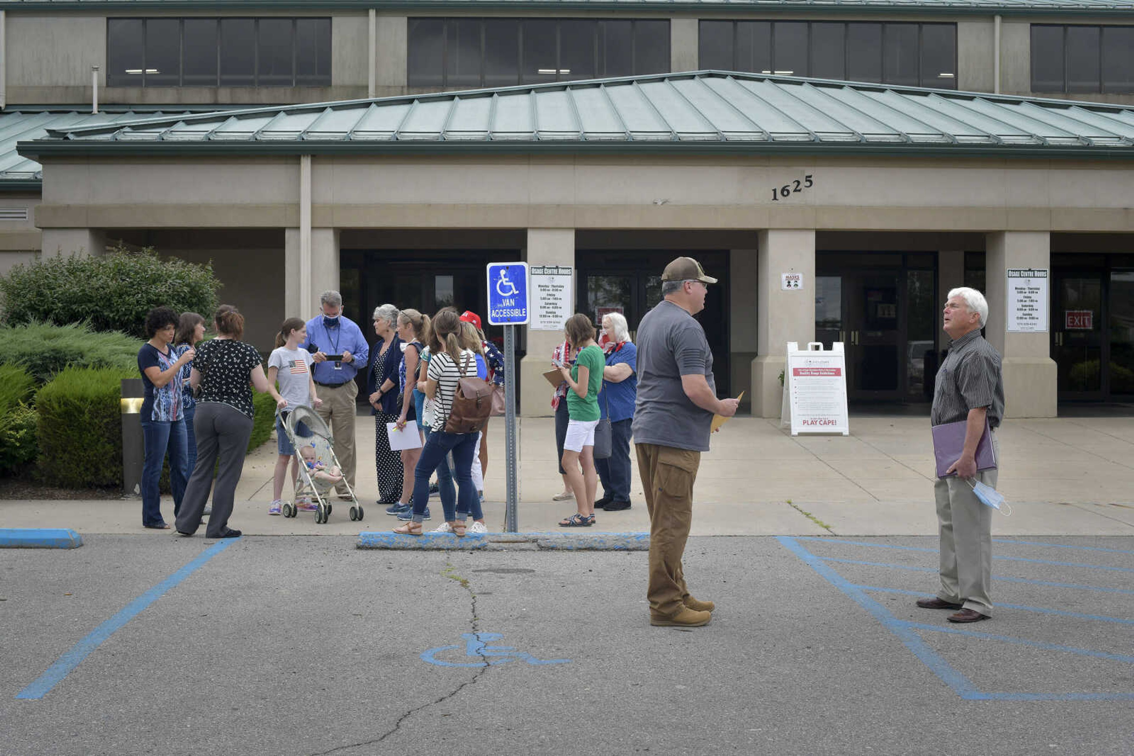 After a Board of Trustees meeting, Cape Girardeau County Public Health Center board member John Freeze discusses the county's mandatory face mask usage ordinance Tuesday, July 28, 2020, outside of the Osage Centre in Cape Girardeau.