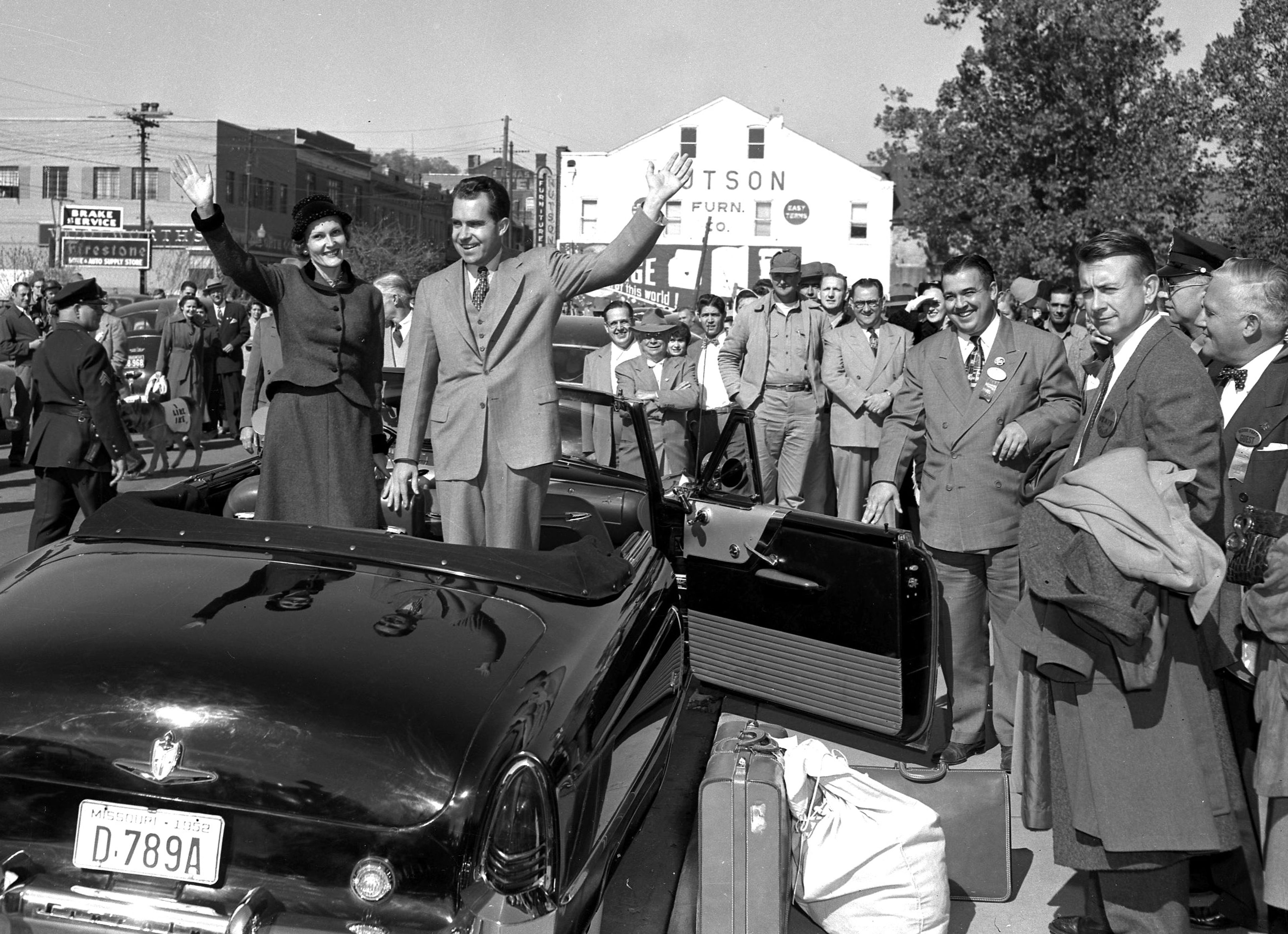 Sen. Richard Nixon and his wife, Pat, wave from the back of a convertible at the Frisco train depot on South Main Street. Sen. Nixon brought his vice-presidential campaign to Cape Girardeau on Oct. 21, 1952. Standing at the open car door is Rush H. Limbaugh Jr., county Republican chairman.
