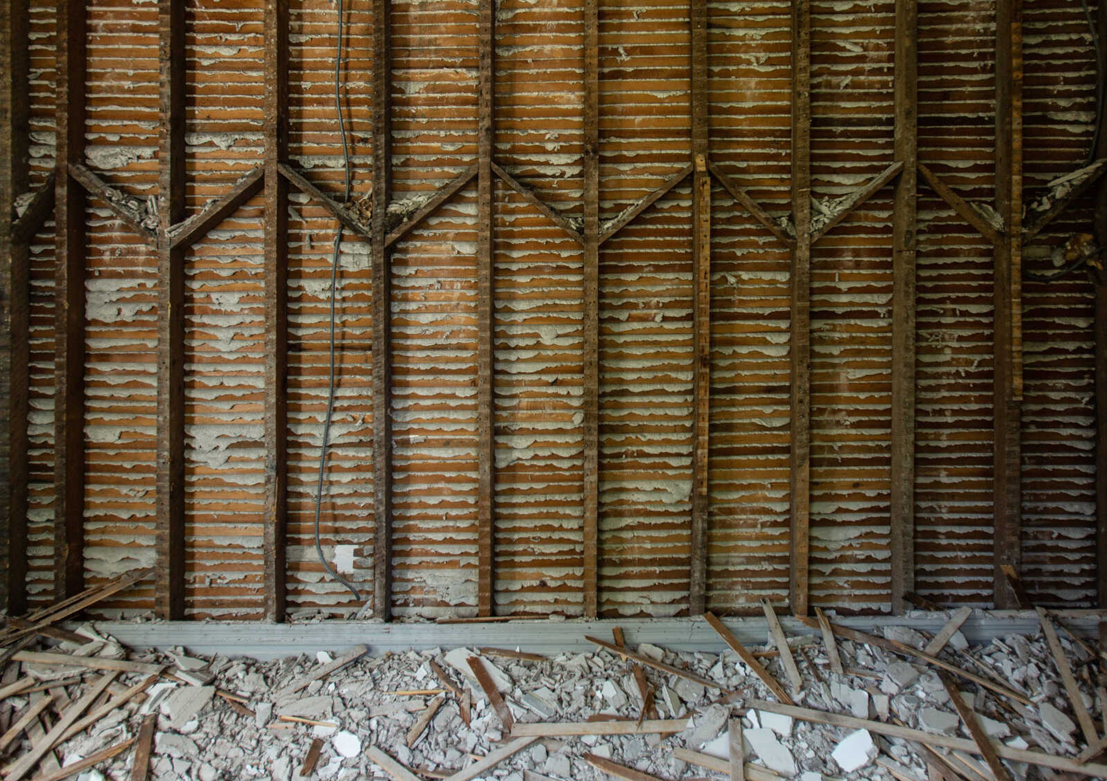 Broken pieces of lath and plaster collect at the foot of an exposed wall as crews continue the demolition phase of the Common Pleas Courthouse renovation on Tuesday, June 16, 2020.