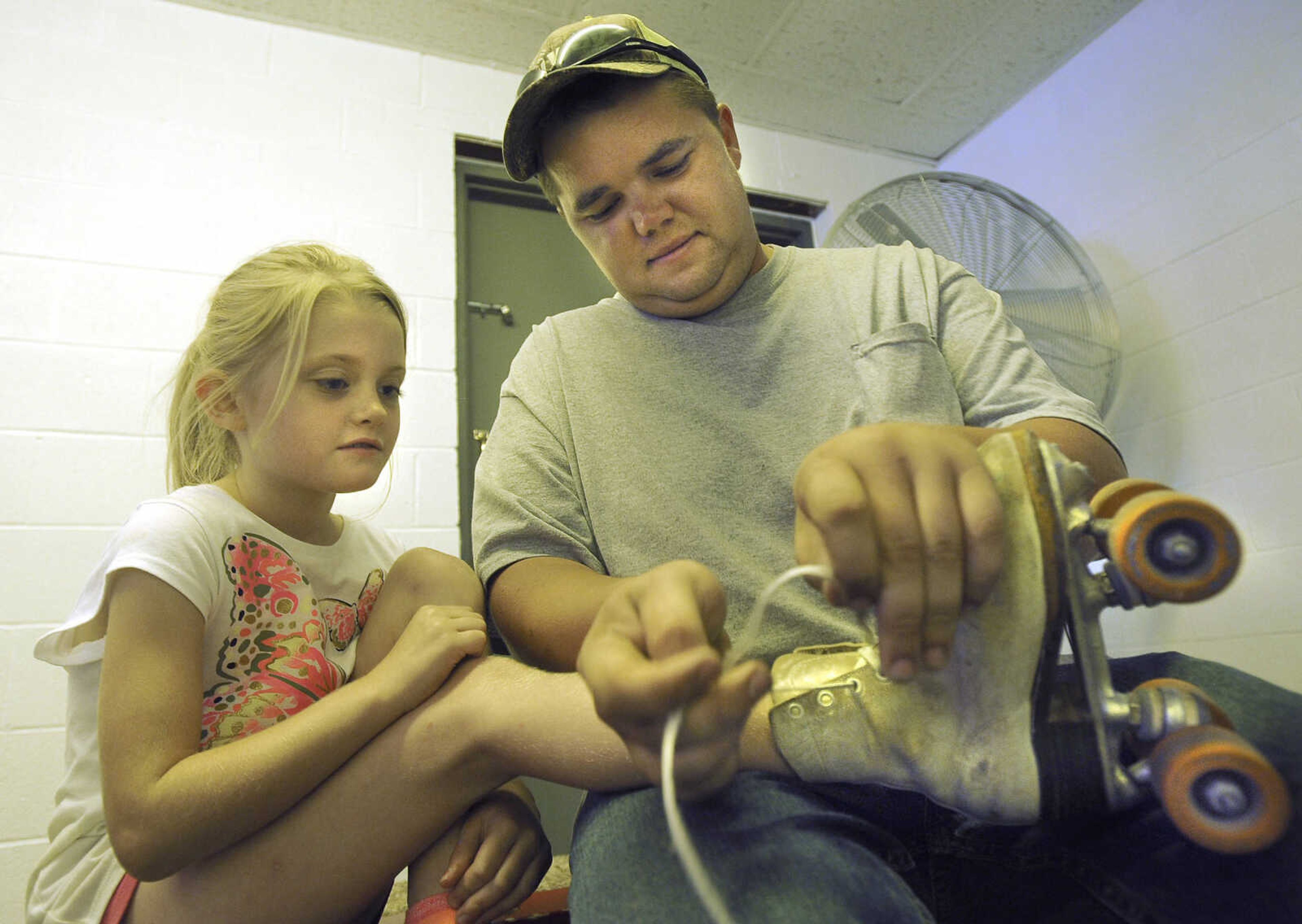 FRED LYNCH ~ flynch@semissourian.com
Trent Elfrink helps his daughter, Mahala Brown, put on her roller skates Sunday, Aug. 12, 2018 at Willow Grove Roller Rink in Chaffee, Missouri.