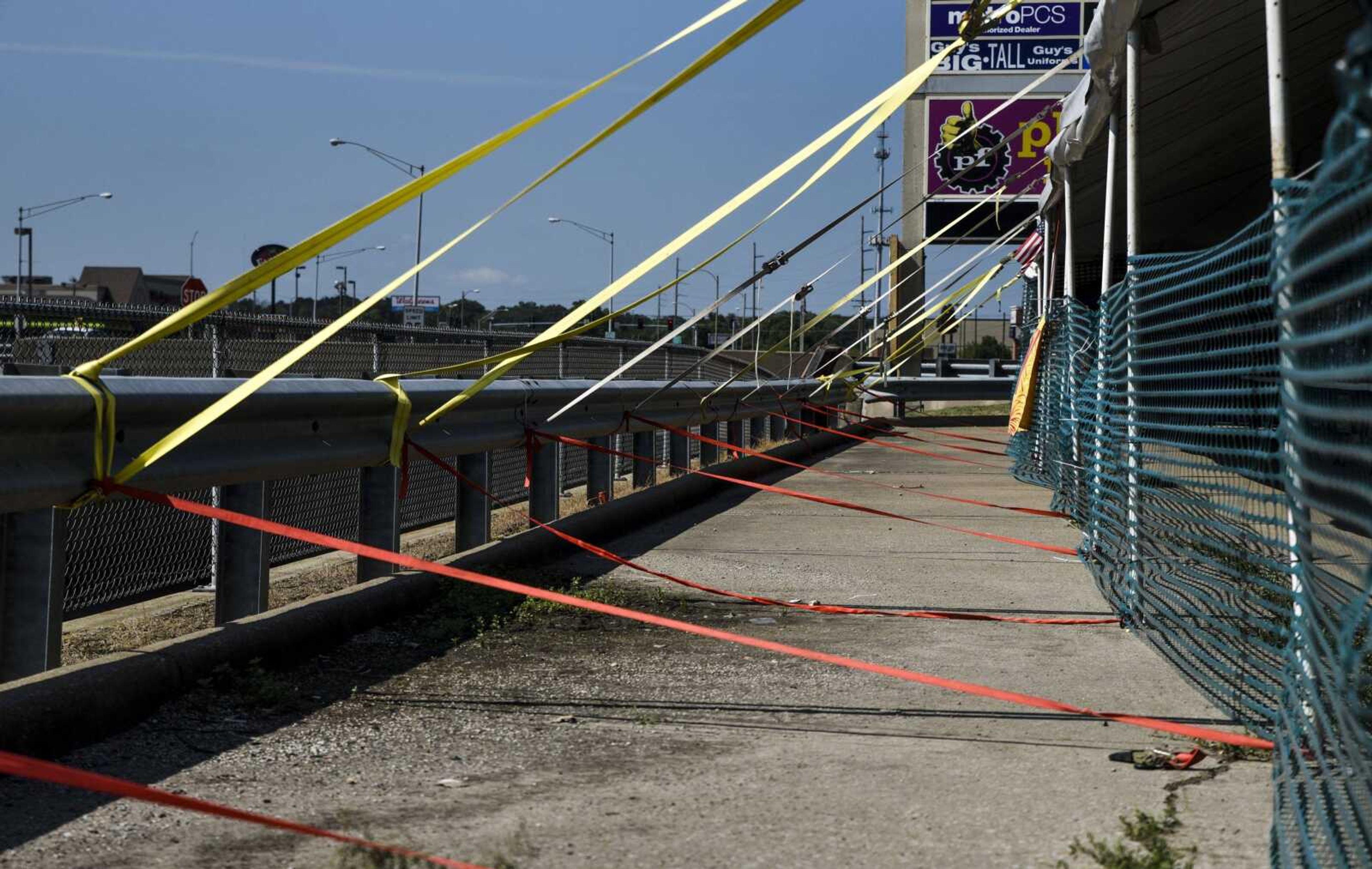 Bands are used to tie the tent of Hoffman Family Fireworks to a guardrail for stability against winds Friday in Cape Girardeau.