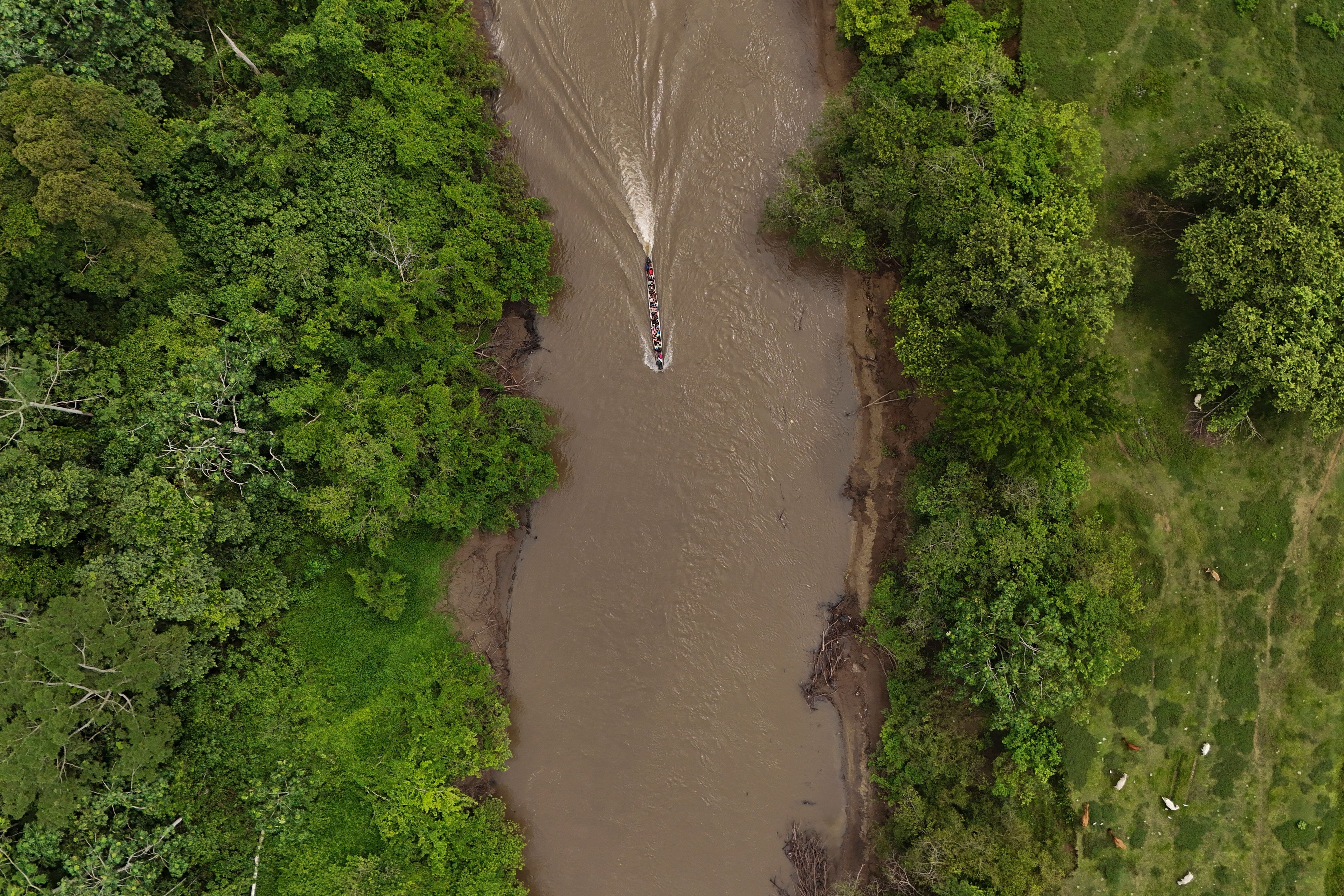 A boat takes migrants to Lajas Blanca, Panama, Thursday, Sept. 26, 2024, after the migrants trekked across the Darien Gap from Colombia in hopes of reaching the U.S. (AP Photo/Matias Delacroix)