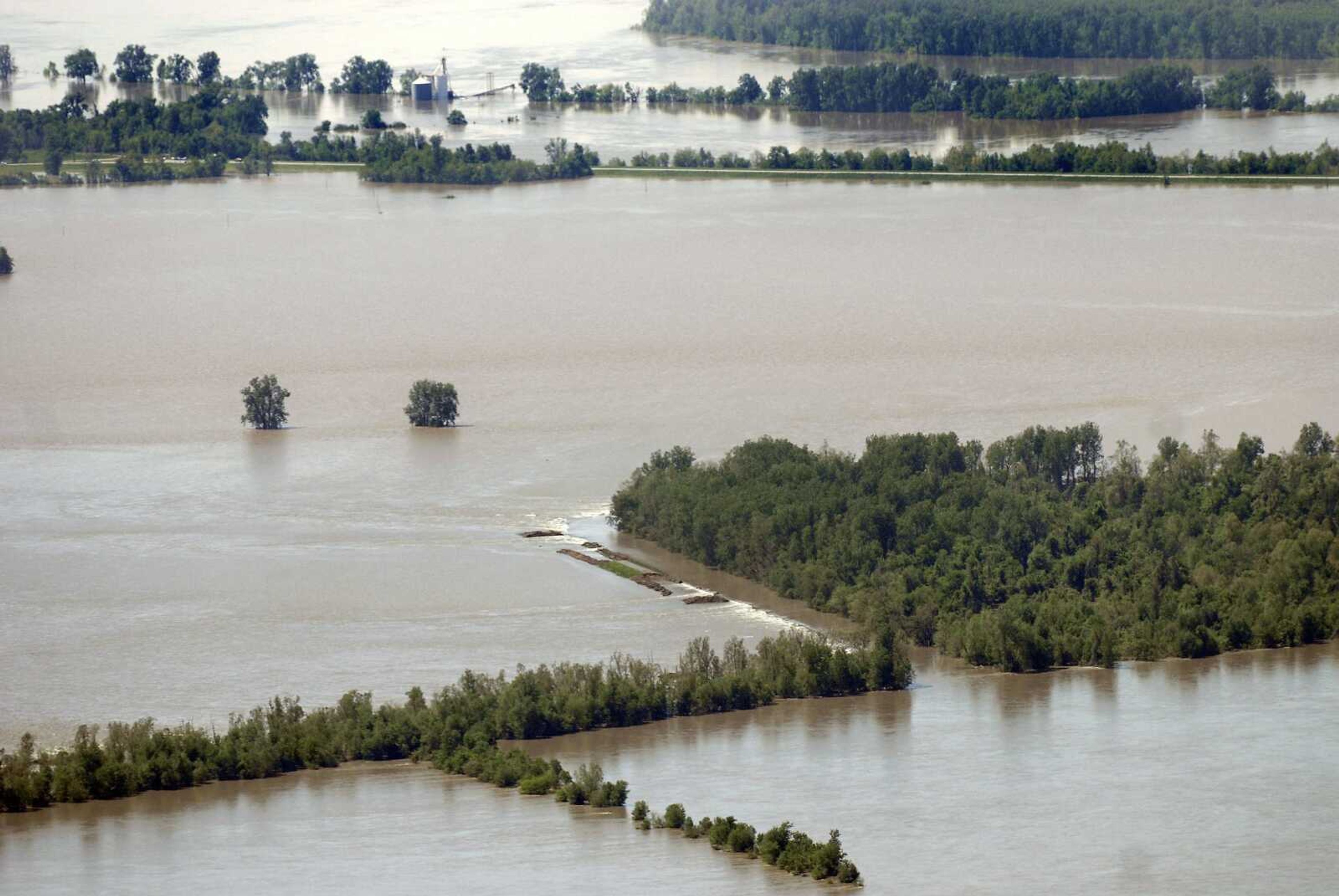 Water flows over the breached section of Birds Point levee in Mississippi County, Mo., on Tuesday, May 3, 2011. On May 2, Maj. Gen. Michael Walsh gave the order to intentionally breach the Birds Point levee, flooding over 130,000 acres of farmland to ease flooding upstream. (Kristin Eberts)