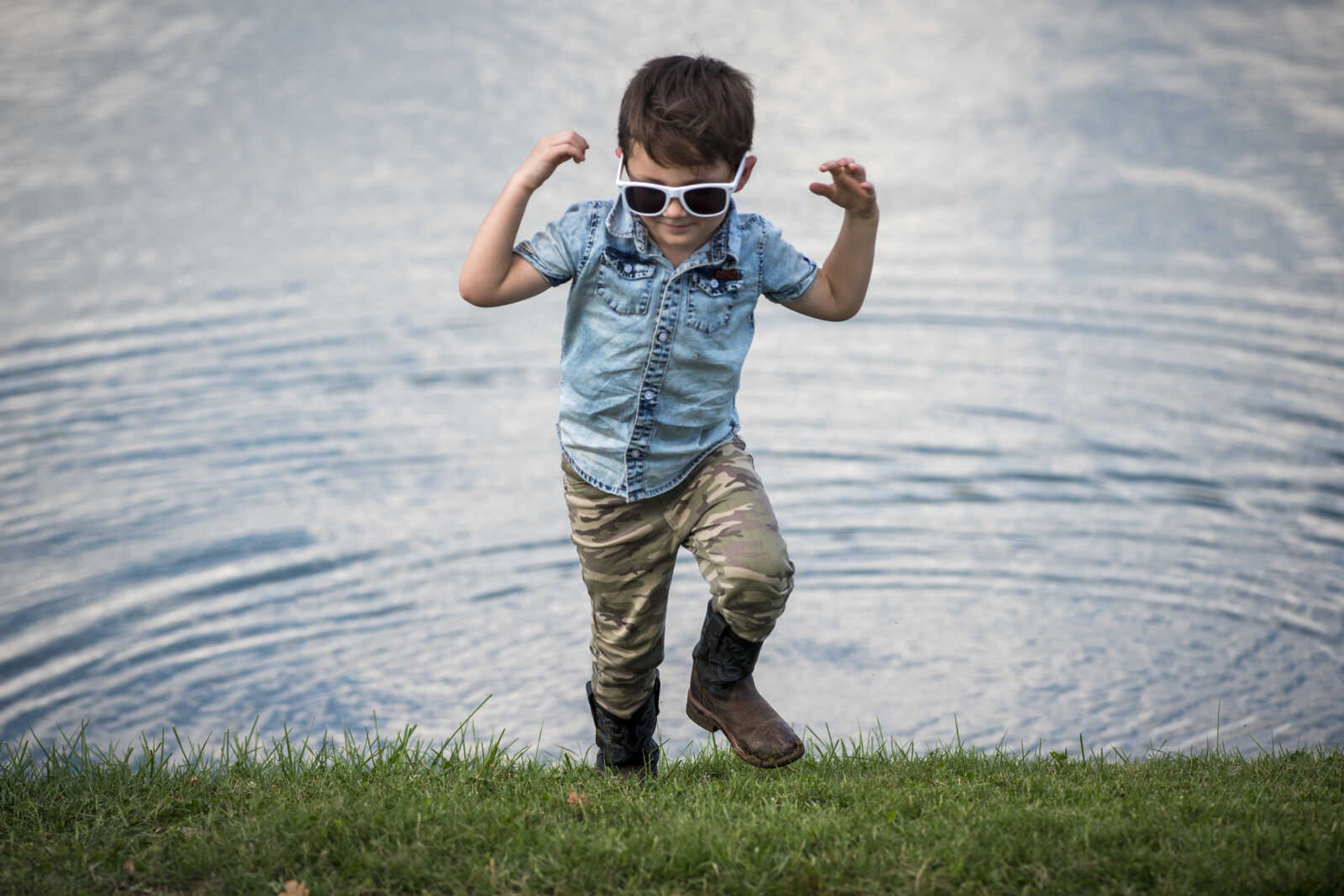 Kage Kurtz, 4, scampers away from the edge of the lake after throwing a rock Sept. 29, 2019, at Cape County Park North.