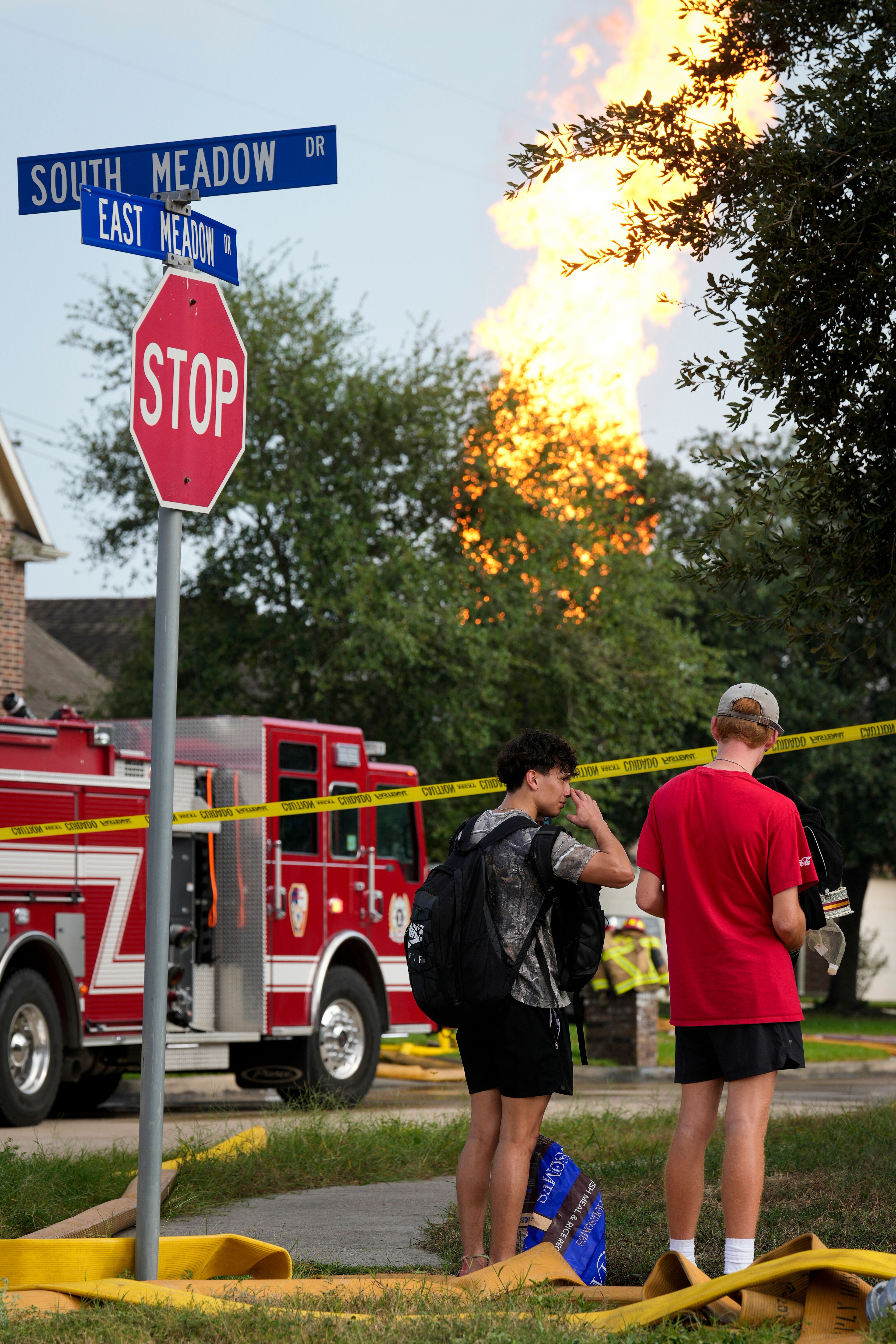 Residents watch the pipeline fire burning in La Porte, Texas, from South Meadow Drive and East Meadow Drive Monday, Sept. 16, 2024, in Deer Park, Texas. (Yi-Chin Lee/Houston Chronicle via AP)