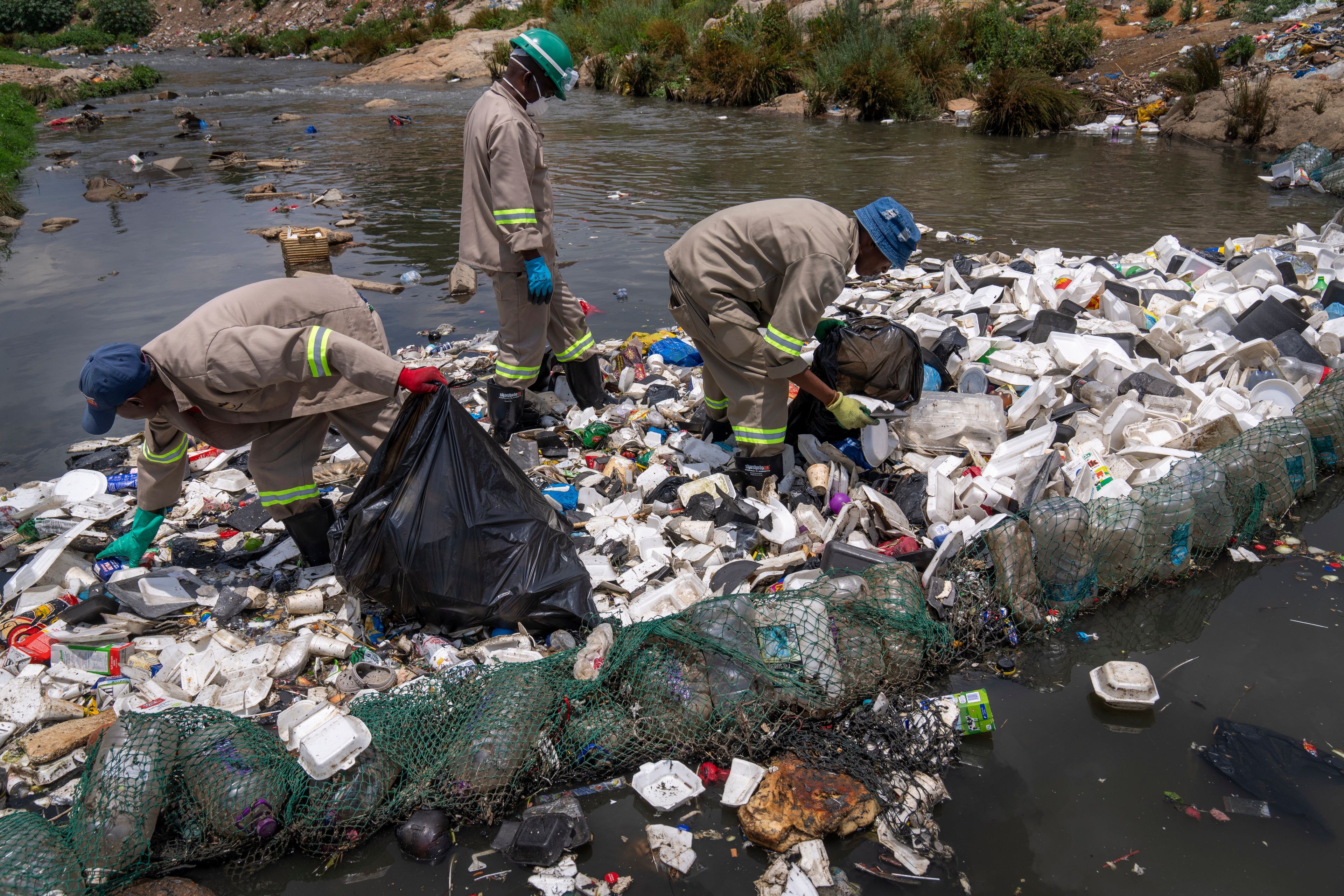 Alexandra Water Warriors volunteers cleanup the Juksei river in the heart of Alexandra township from Plastic pollution in Johannesburg, South Africa, Wednesday, Nov. 27, 2024. (AP Photo/Jerome Delay)