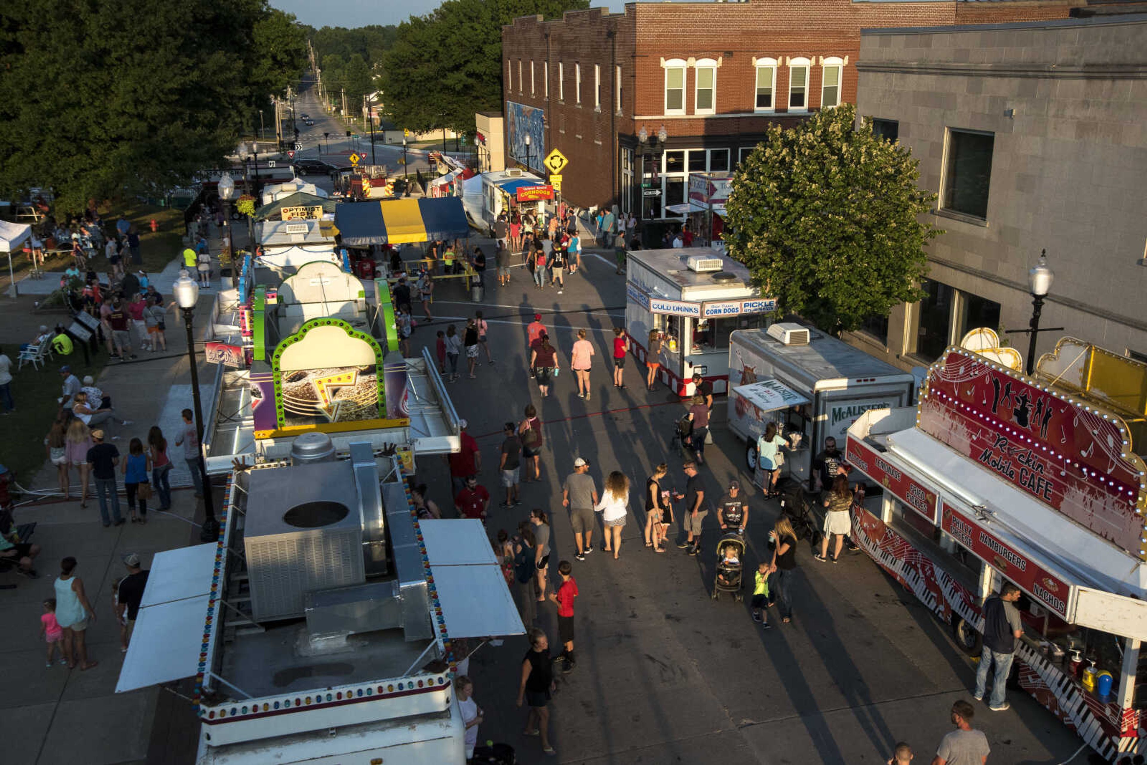 People roam around at the Jackson Homecomers Tuesday, July 25, 2017 in Uptown Jackson.