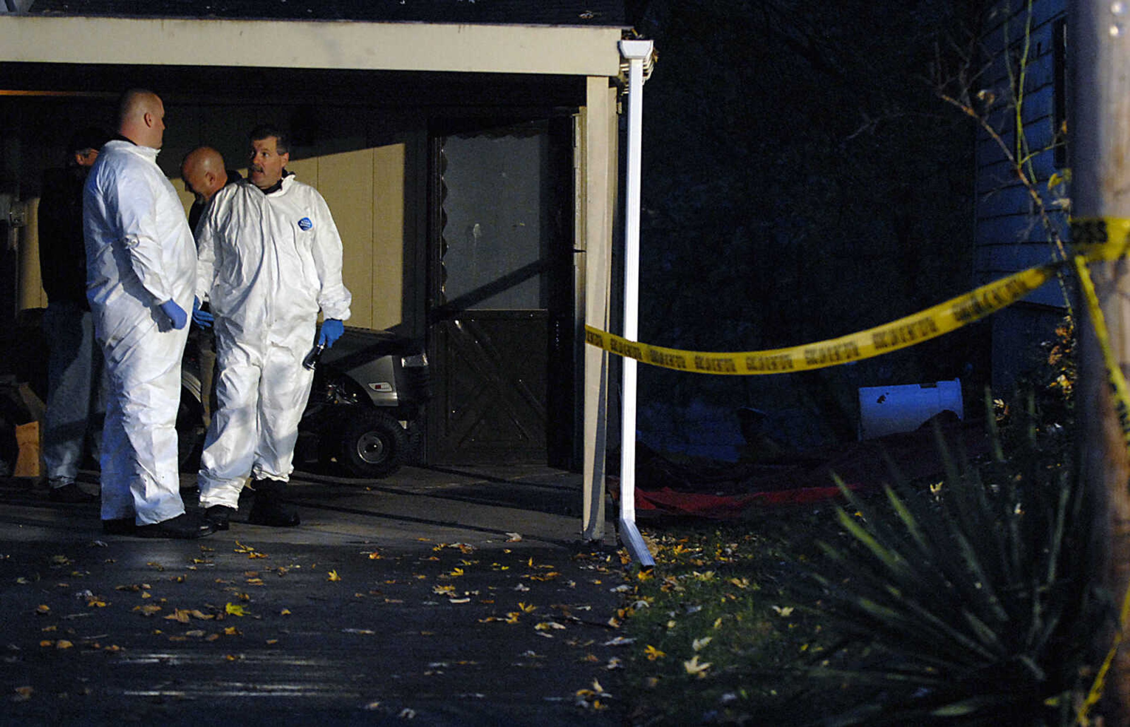 KIT DOYLE ~ kdoyle@semissourian.com
Investigators talk outside 1224 N. Missouri St. Tuesday morning, October 27, 2009, in Cape Girardeau.  There was a double homicide at the residence early Tuesday morning.