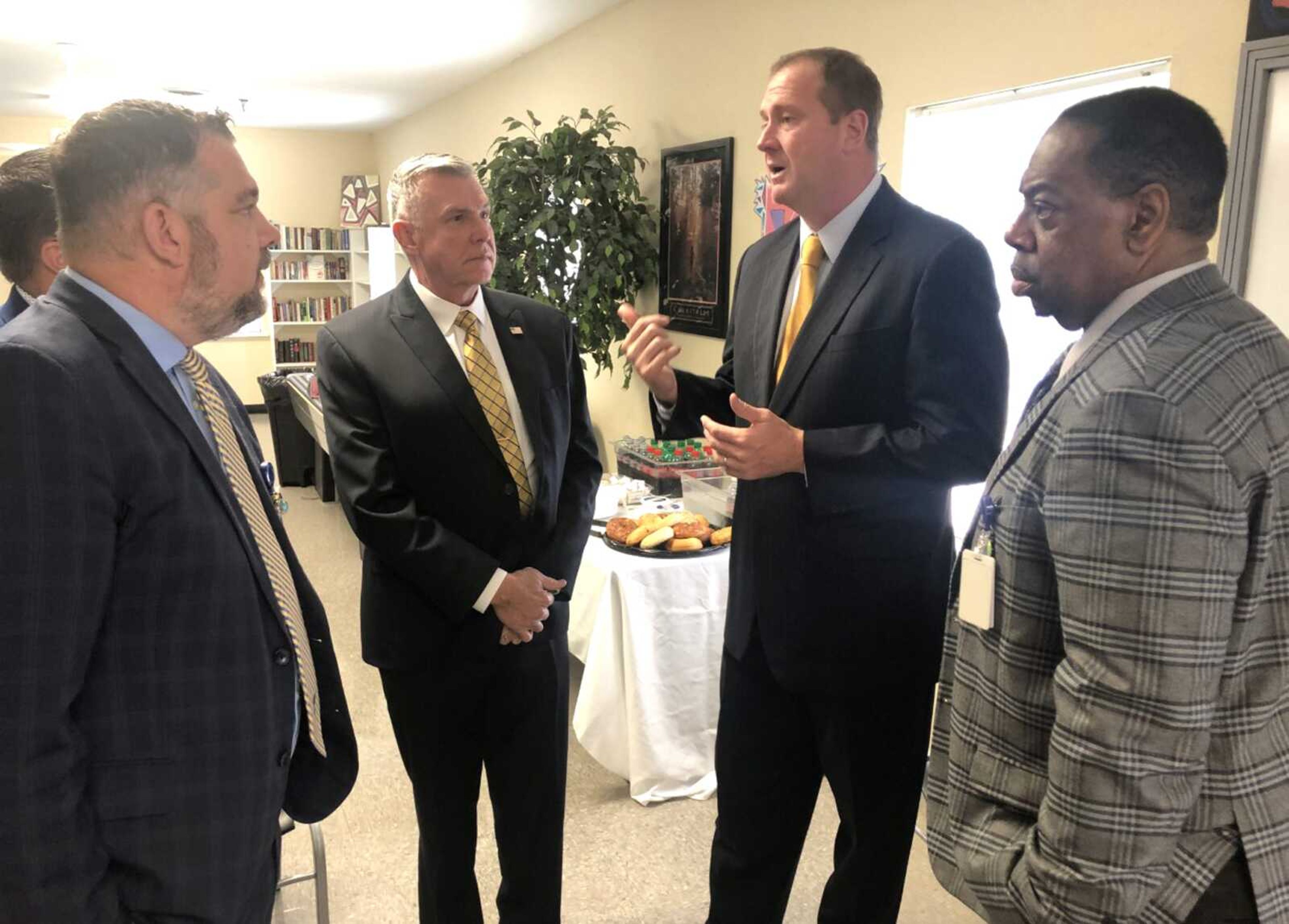 Missouri Attorney General Eric Schmitt, second from right, discusses the state's opioid litigation settlement with, from left, Gibson Recovery Center COO Ryan Essex, FCC Behavioral Health CEO Randy Ray, and Gibson CEO John Gary during a meeting Monday at the Gibson Center.