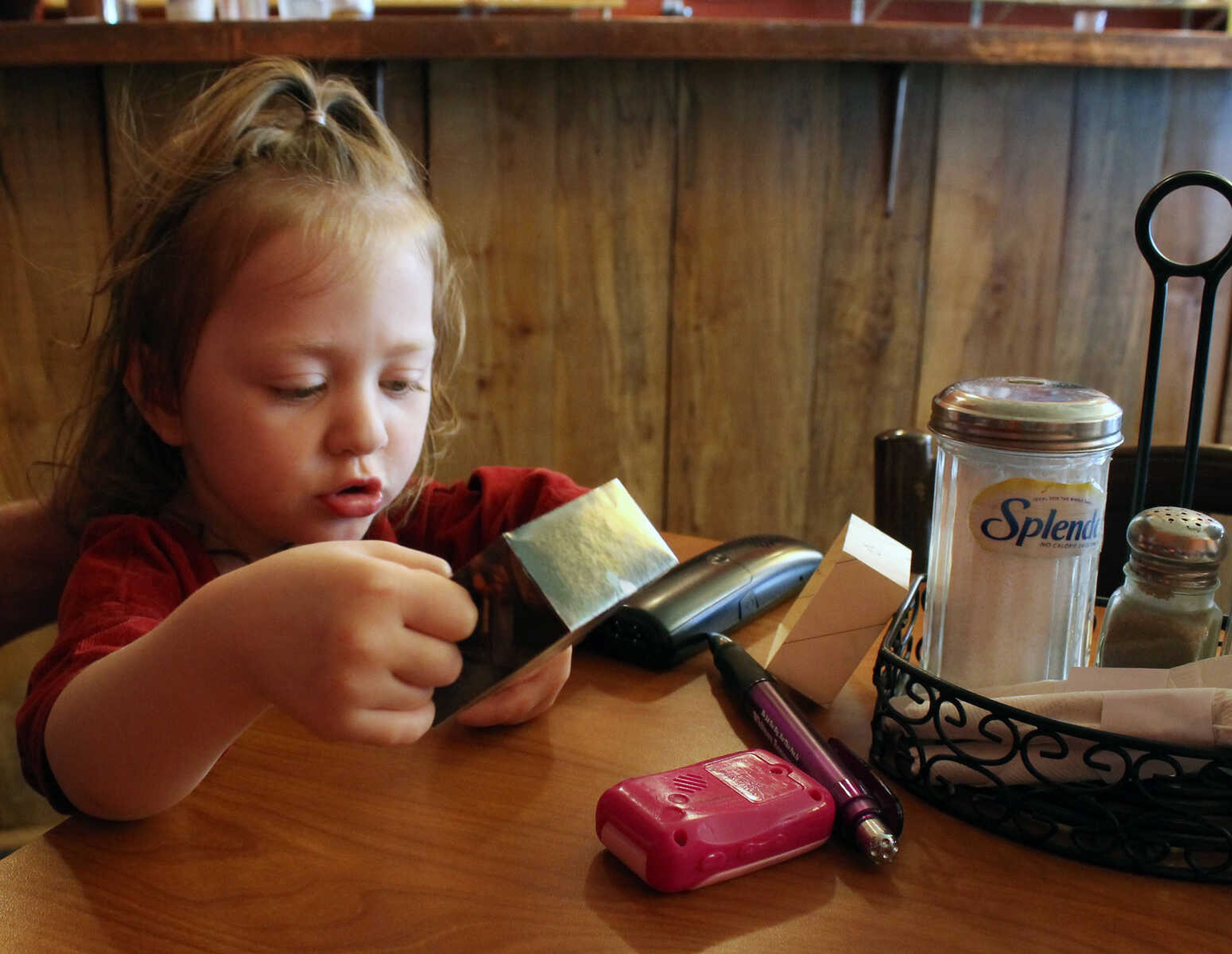 Emily Priddy ~ epriddy@semissourian.com
Mya Buchheit, 3, tells her grandfather, Jim Buchheit, about a gift she received from a friend Friday, March 10, 2017, in her mother's restaurant, the Yellow Moon Cafe in Cobden, Illinois.