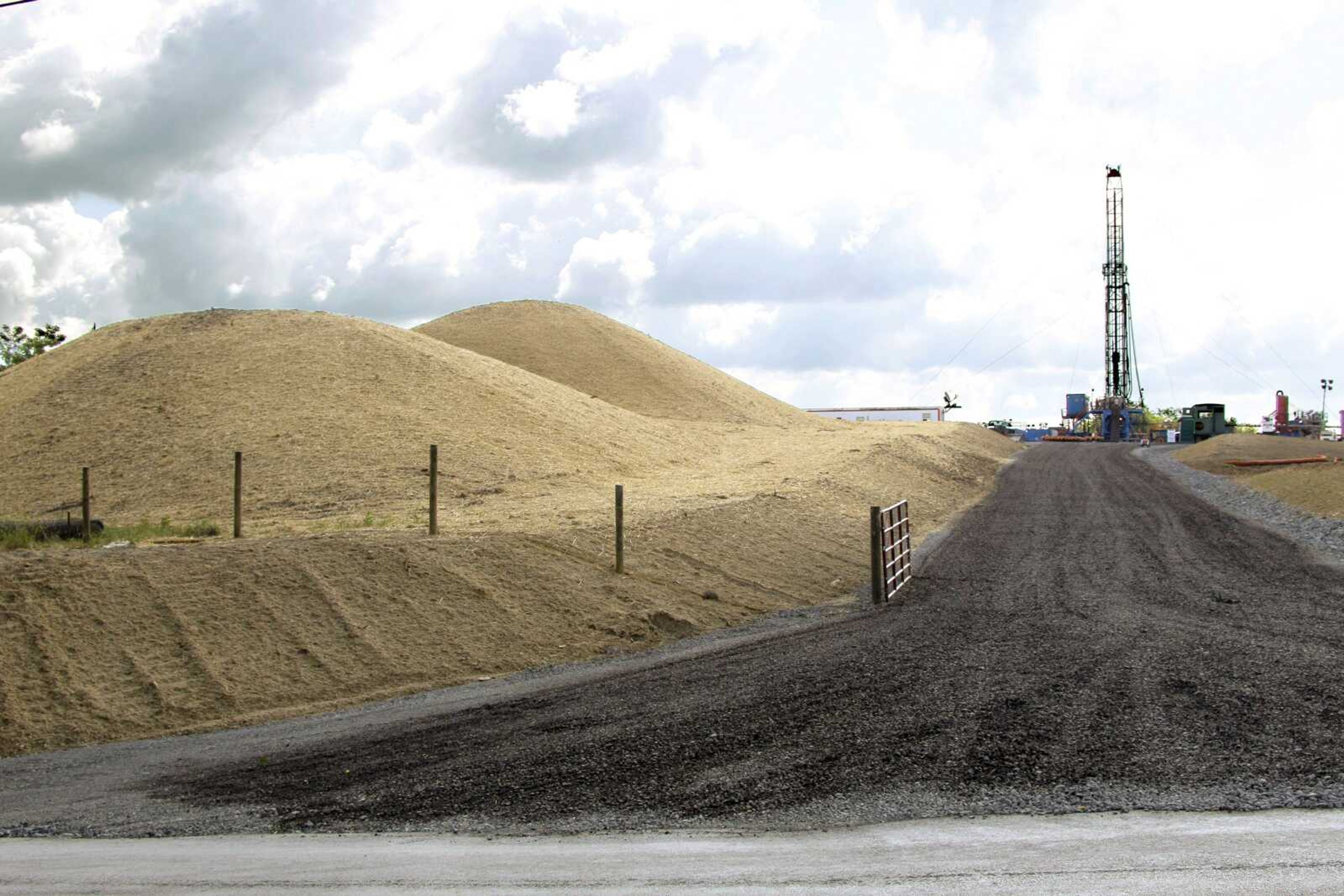 A crew works on a drilling rig at a well site June 25 for shale based natural gas in Zelienople, Pa. (Keith Srakocic ~ Associated Press)