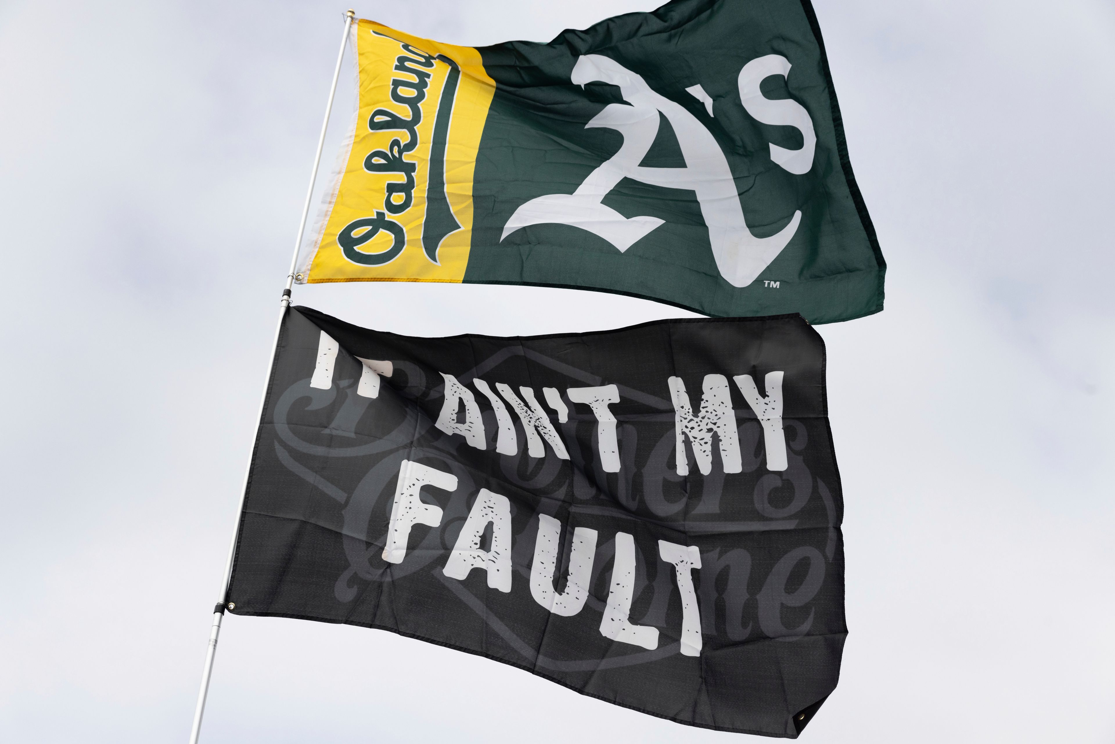 An Oakland Athletics flag flies outside the Oakland Coliseum before a baseball game between the Oakland Athletics and the Texas Rangers Thursday, Sept. 26, 2024, in Oakland, Calif. (AP Photo/Benjamin Fanjoy)