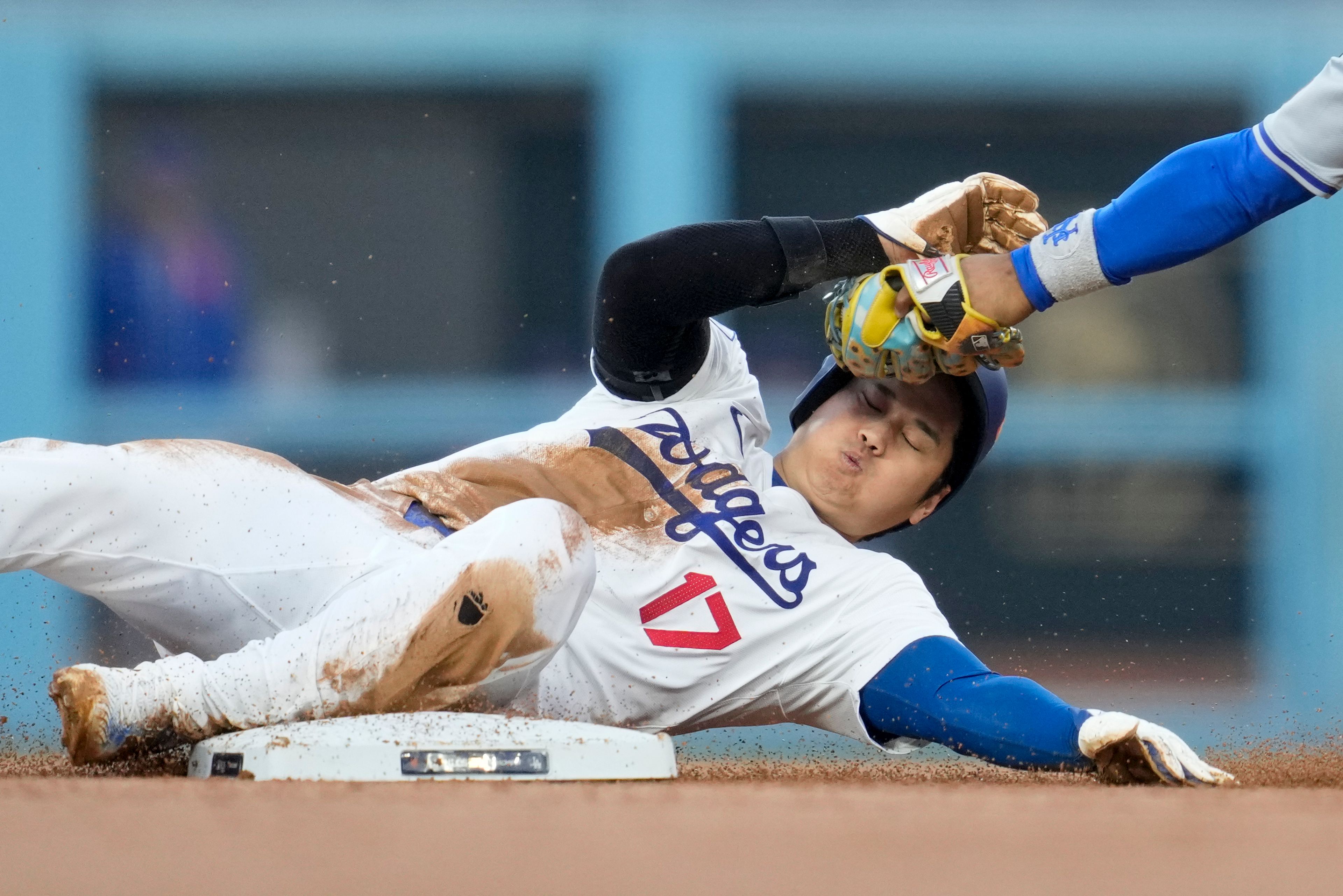 Los Angeles Dodgers' Shohei Ohtani gets caught stealing by New York Mets shortstop Francisco Lindor during the second inning in Game 1 of a baseball NL Championship Series, Sunday, Oct. 13, 2024, in Los Angeles. (AP Photo/Ashley Landis)