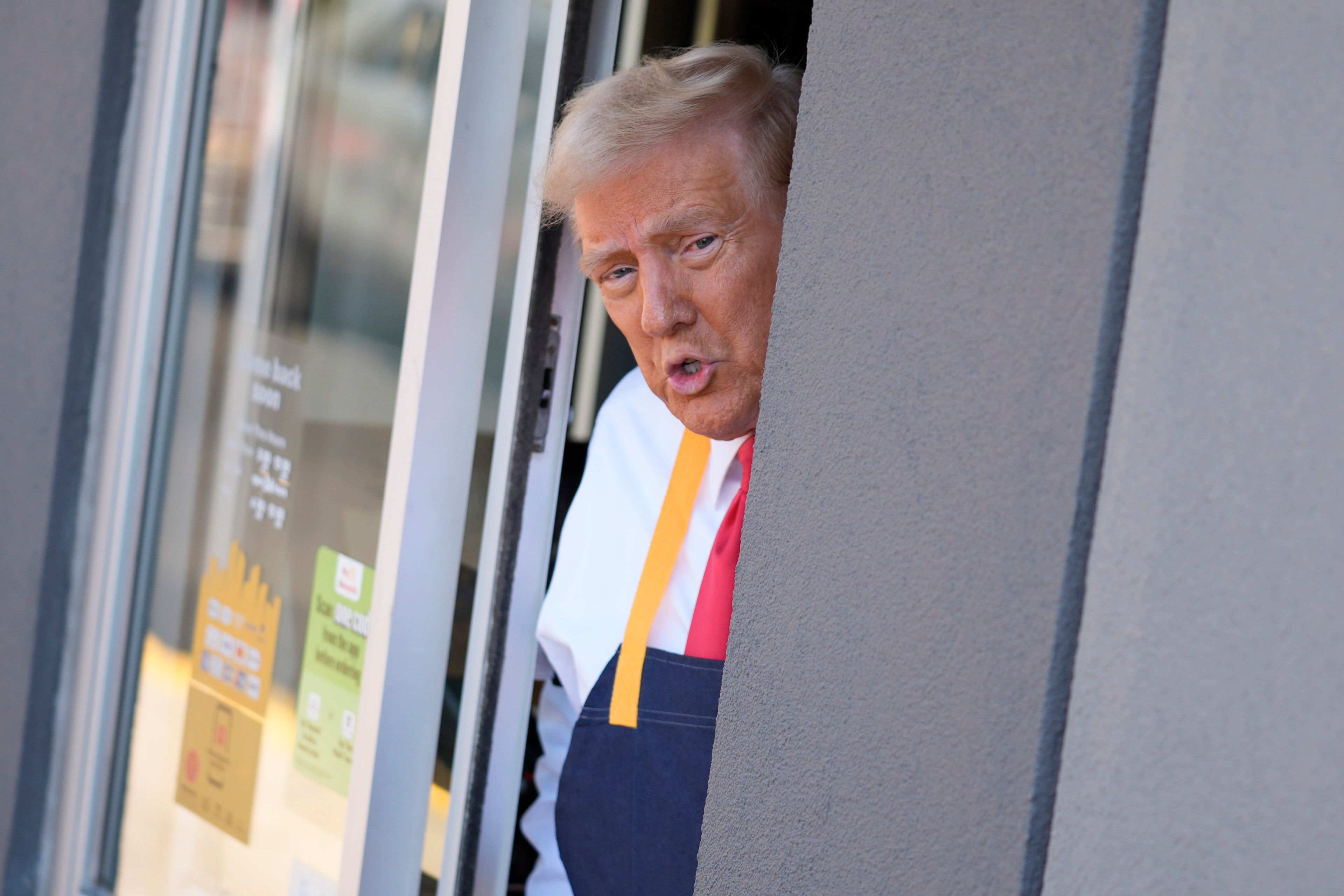 Republican presidential nominee former President Donald Trump speaks from a drive-thru window during a campaign stop at a McDonald's, Sunday, Oct. 20, 2024, in Feasterville-Trevose, Pa. (AP Photo/Evan Vucci)